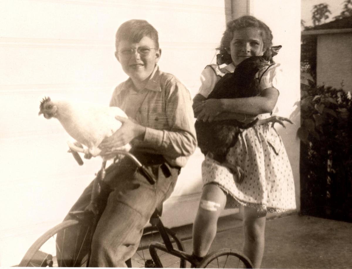 Richard, sister Jean, and pet chickens.