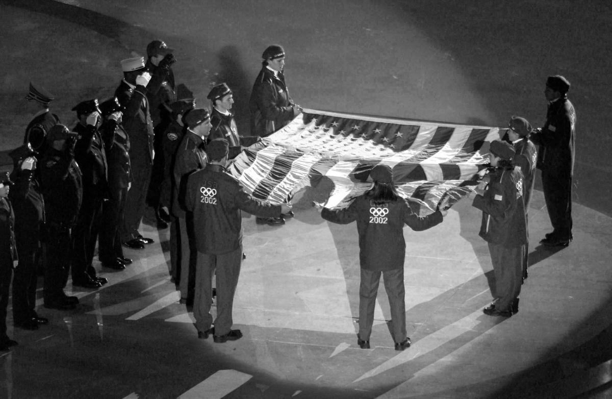 United States Olympic team holding the American flag