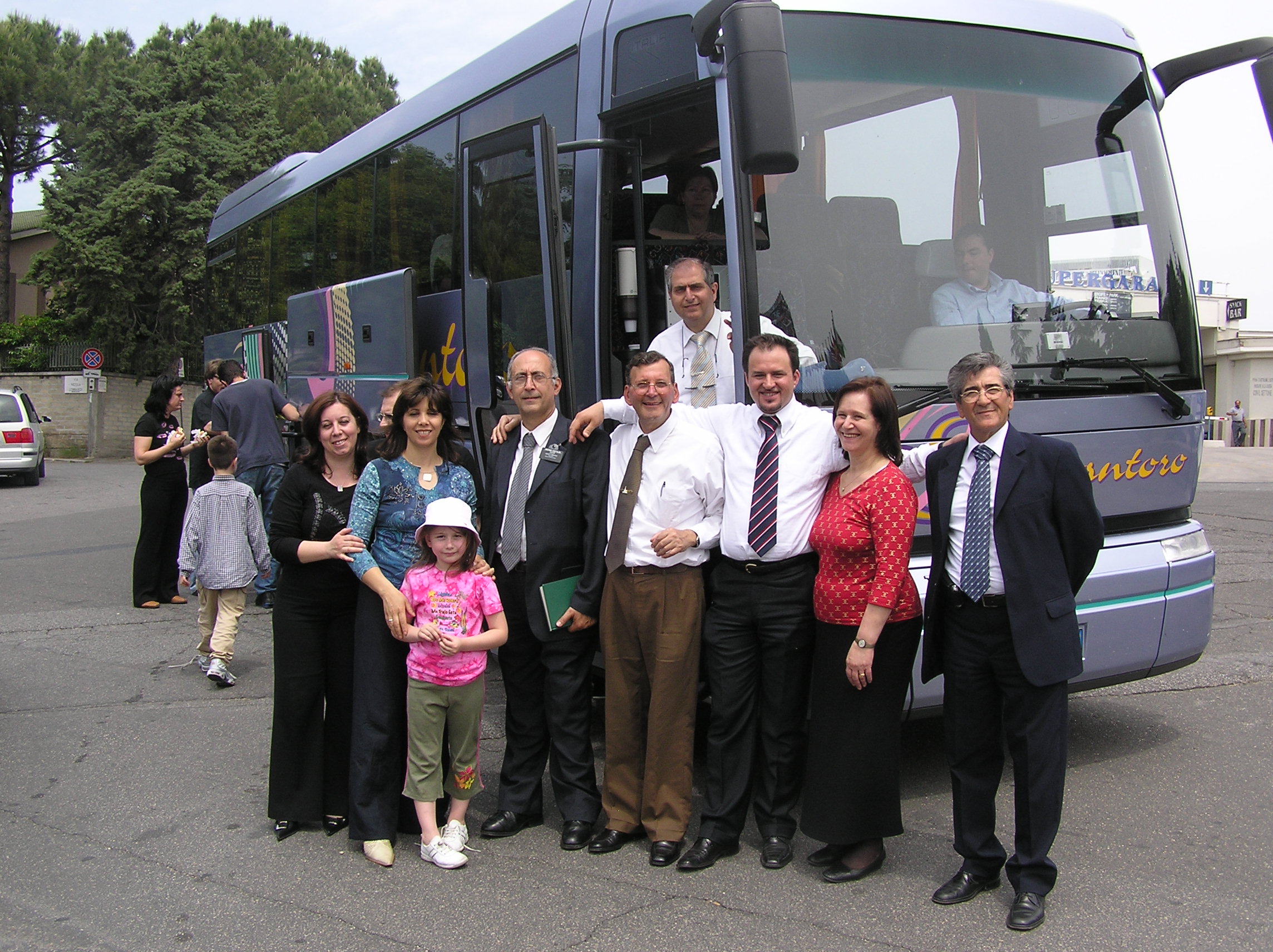 members in front of a bus