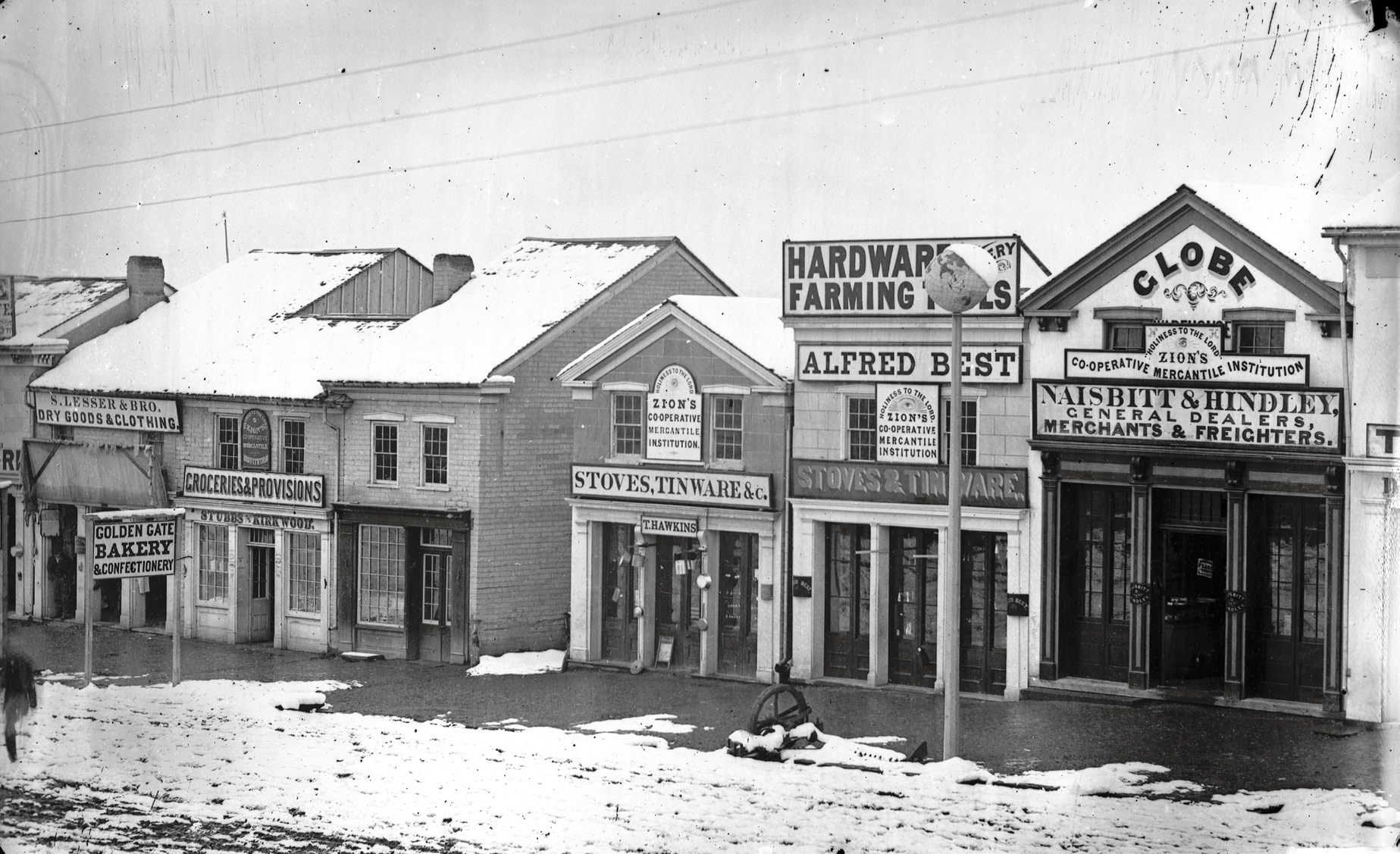 Storefronts along Main Street in Salt Lake City display signs showing their affiliation with ZCMI circa 1869. Much more than just a marketing ploy, “Holiness to the Lord” indicated that participation was preparation for living a celestial law. Courtesy of the Church History Library.