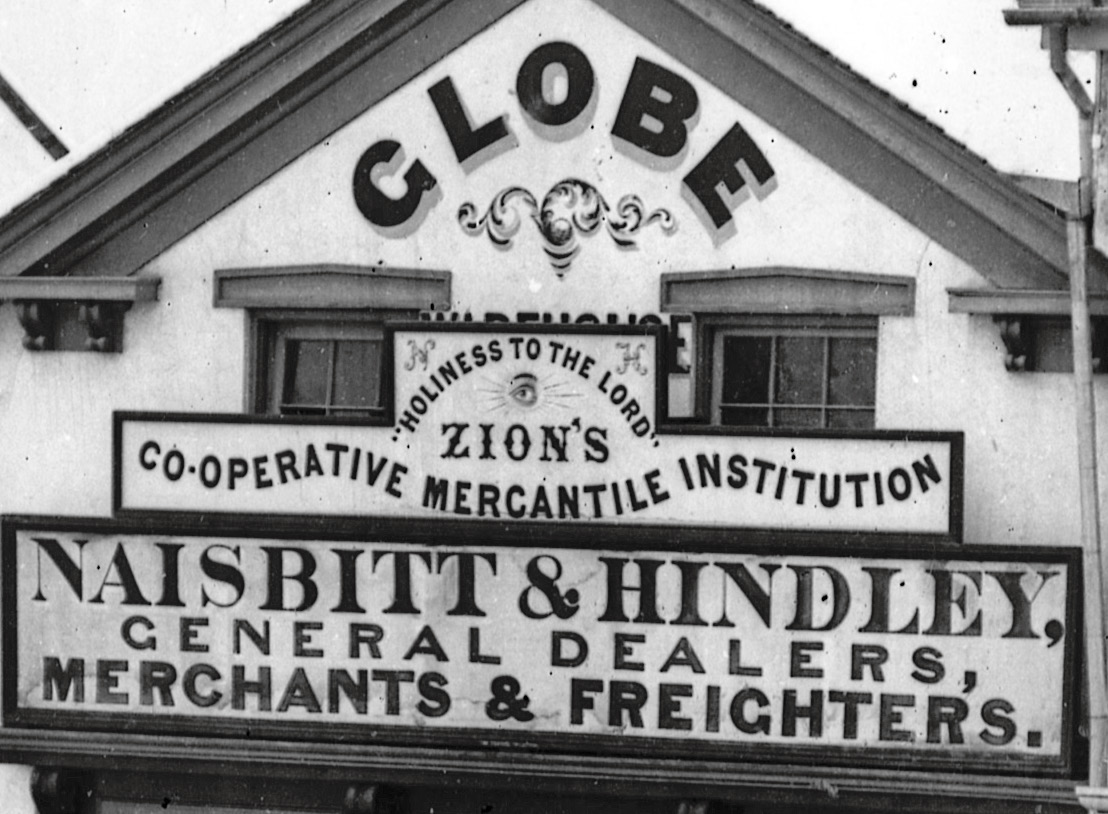 Detail from above showing “Holiness to the Lord” on the store sign.