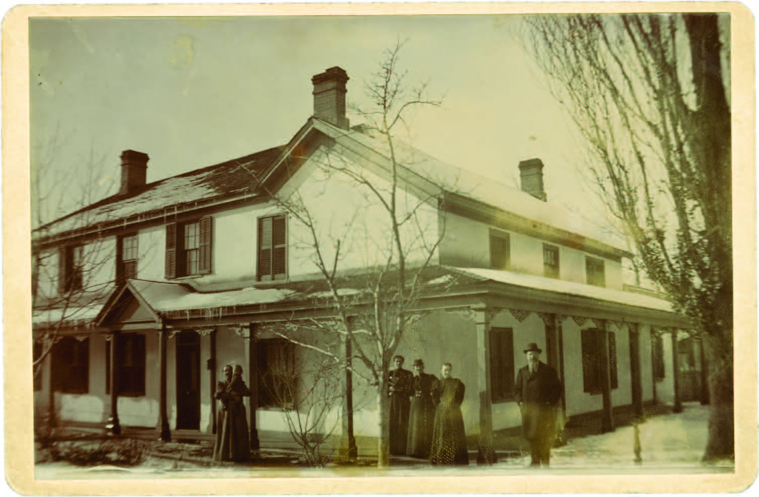 people standing on the porch of a home