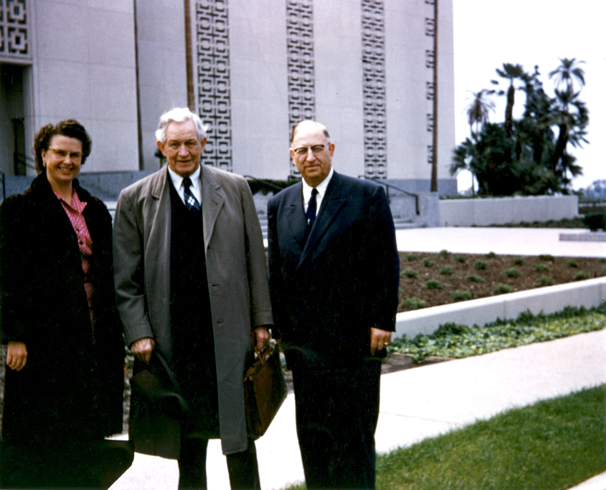 three people outside the temple