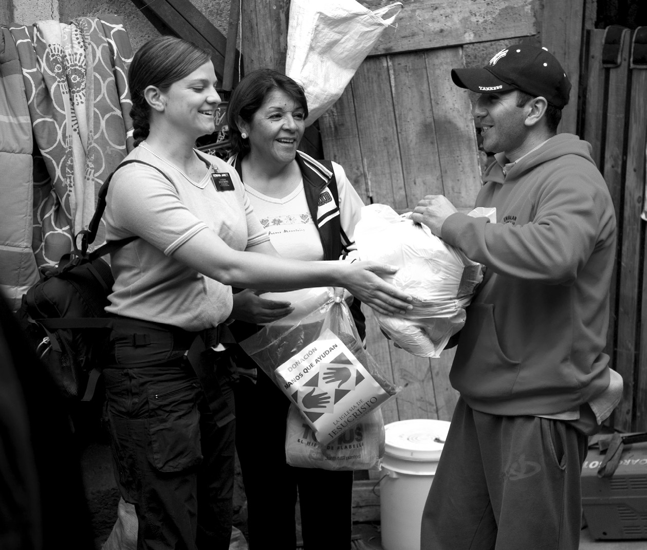 two sister missionaries helping a man