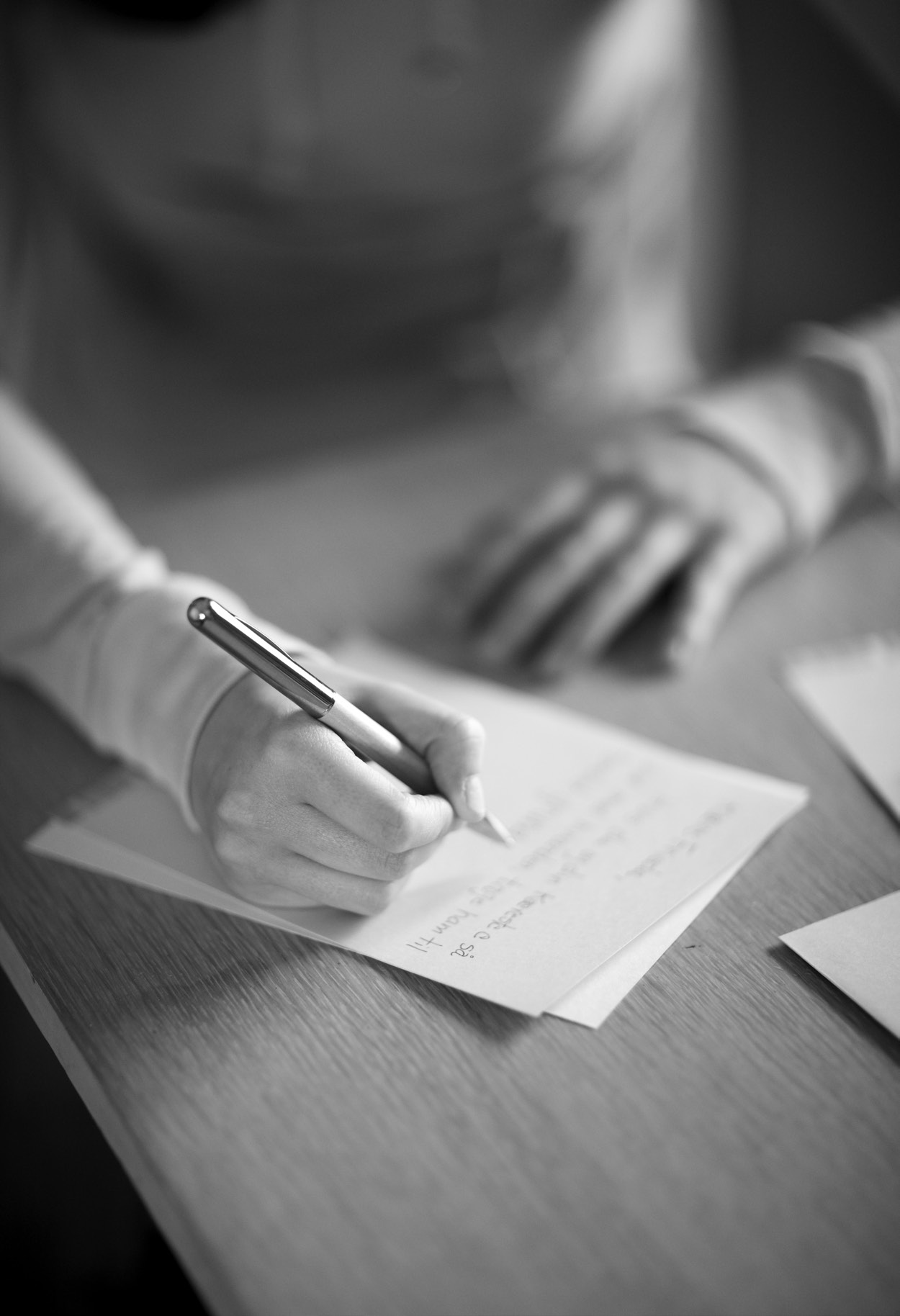 a person writing on a paper