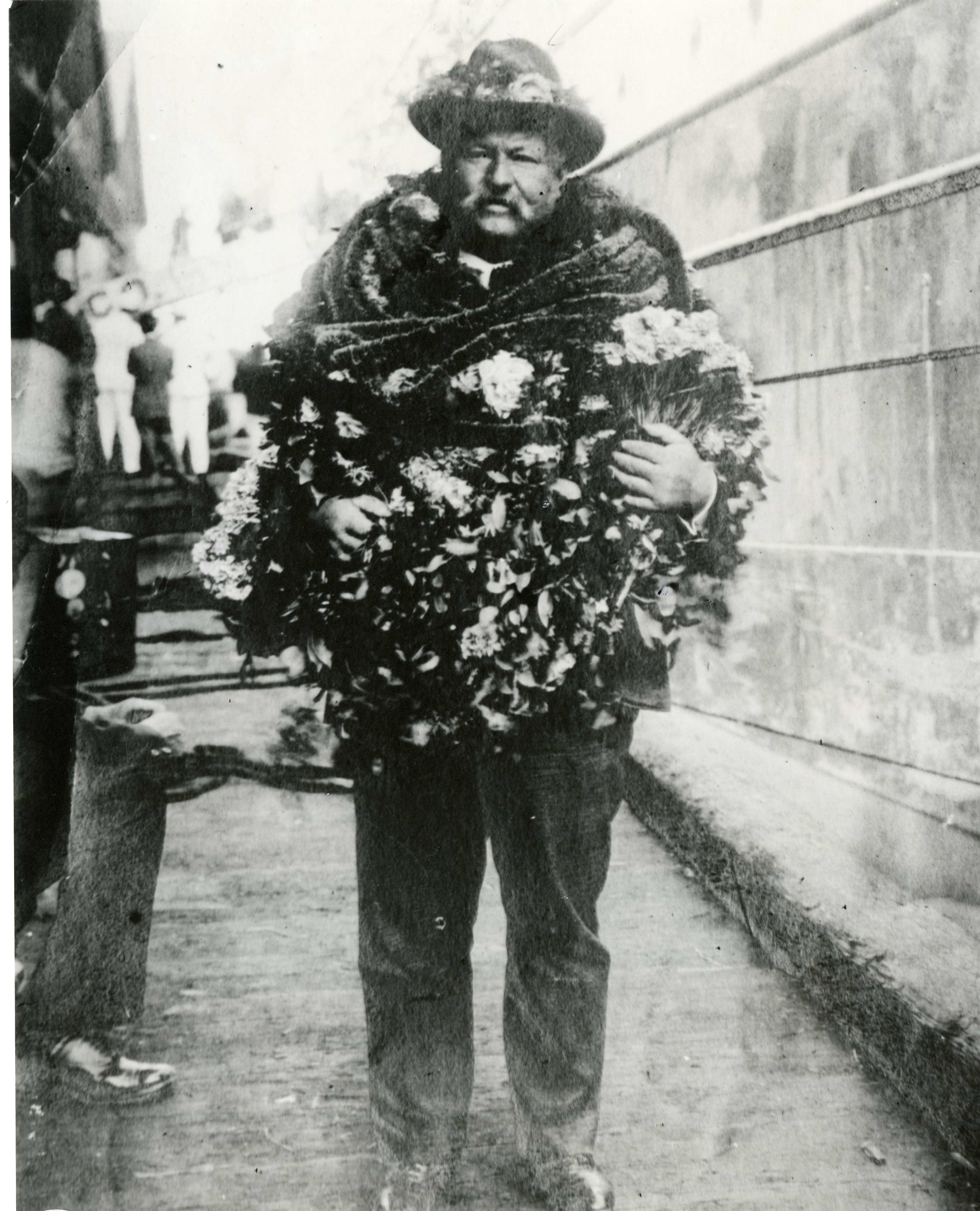 guy with a lot of leis