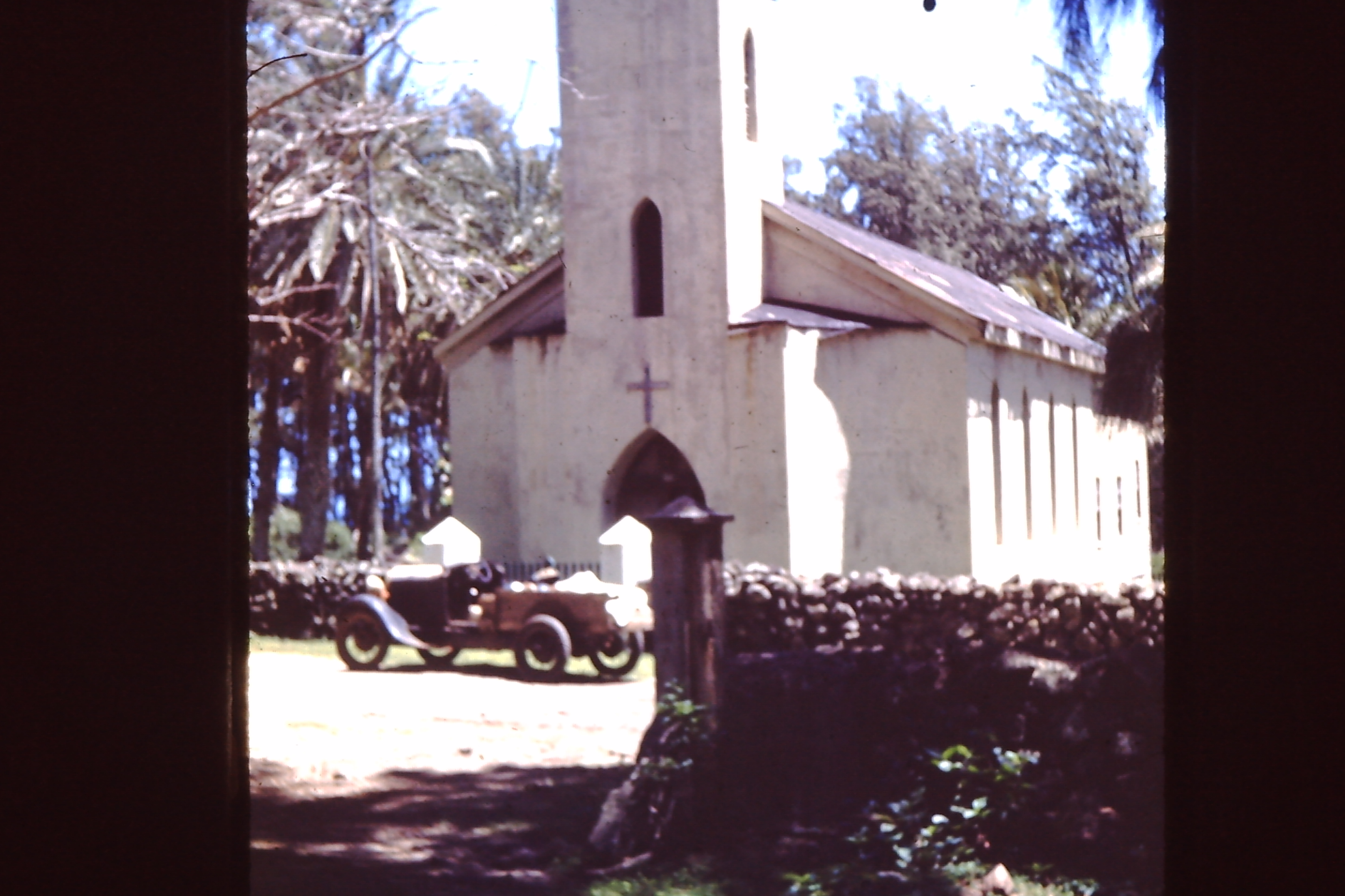 very old car in front of a church