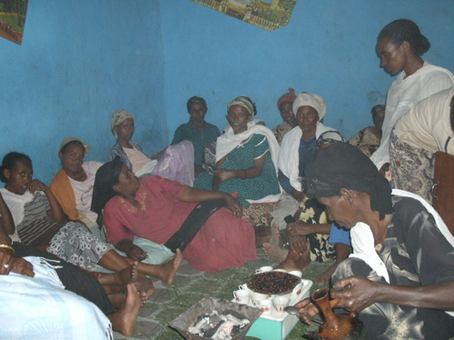 A group of Ethiopian women gather in a buna ceremony for a microfinance meeting.