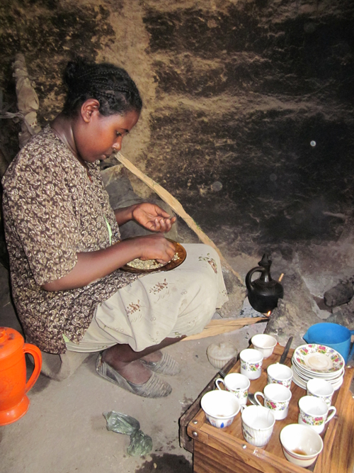 An Ethiopian woman sorting coffee beans