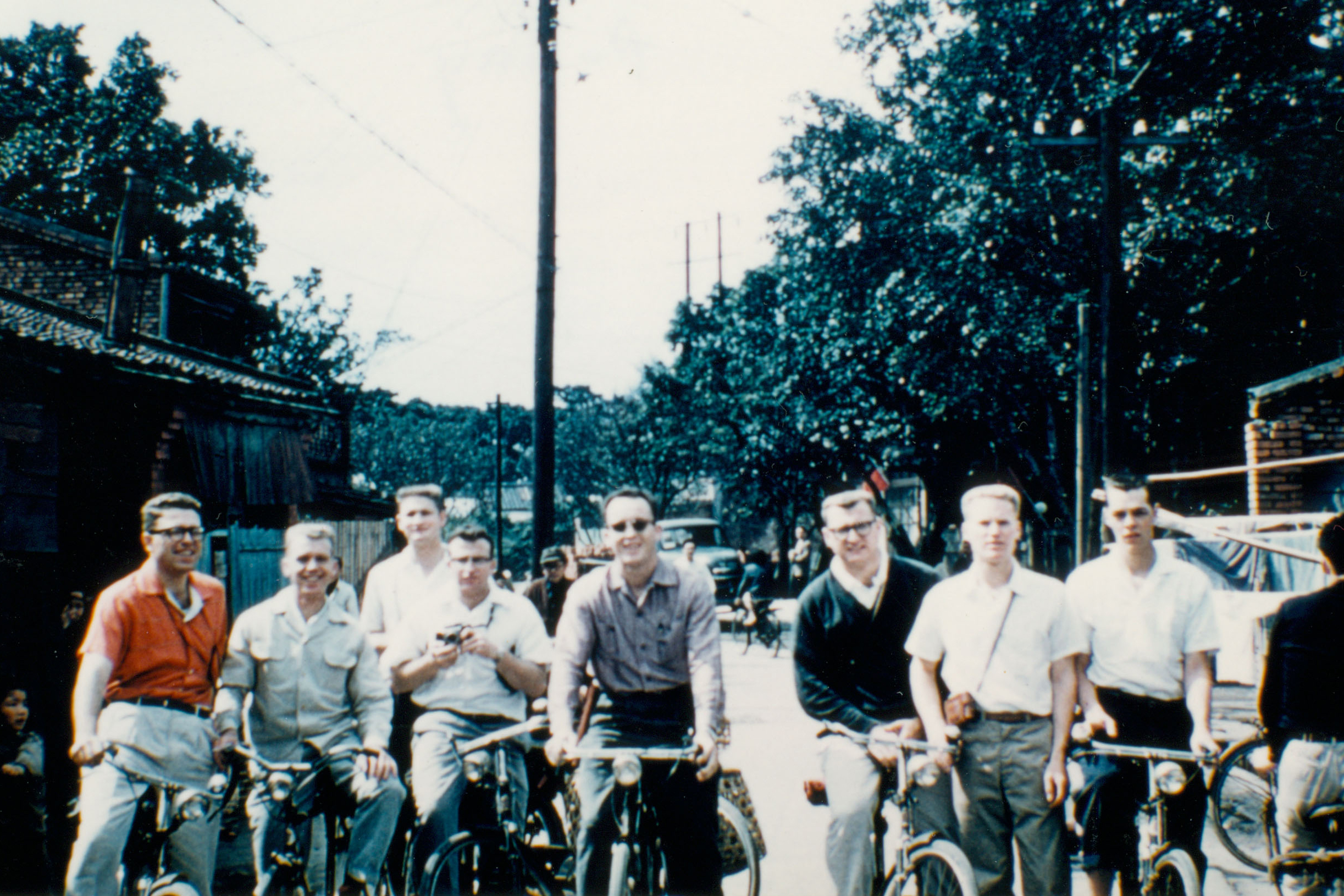 Eight missionaries biking in 1957
