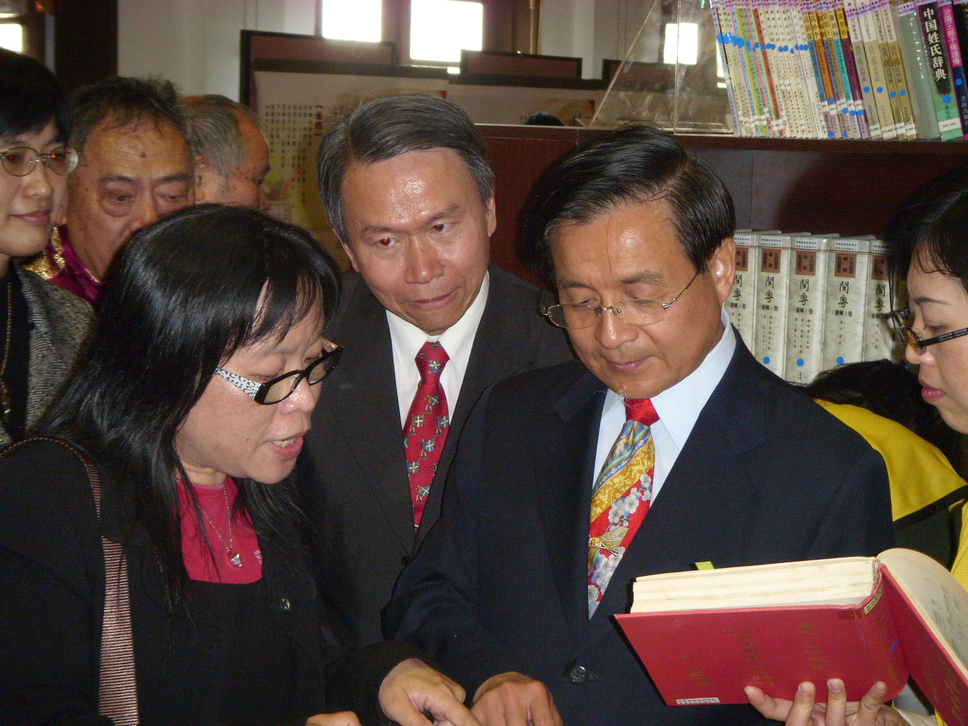 several people looking at a book