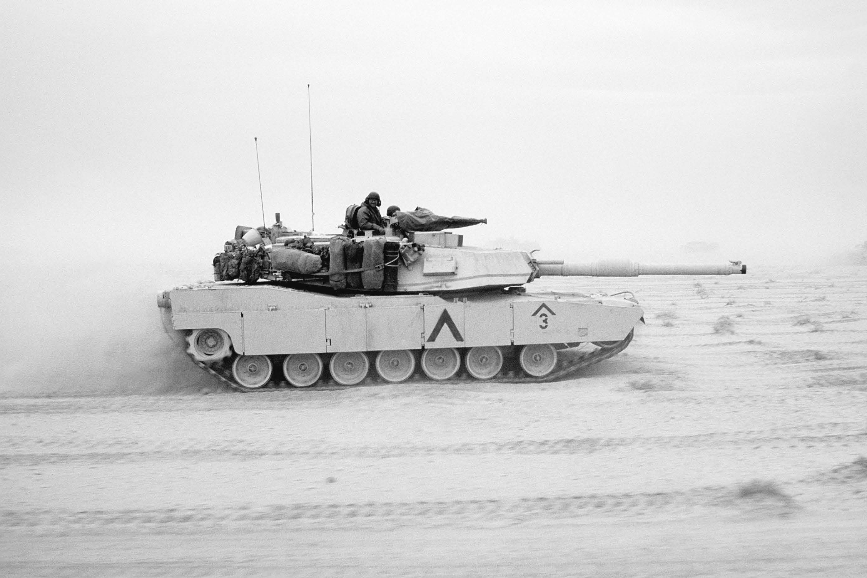 An M-1A1 Abrams battle tank of 1st Armored Division, 7th Corps, moves across the desert in northern Kuwait during Operation Desert Storm. Courtesy of DoD.