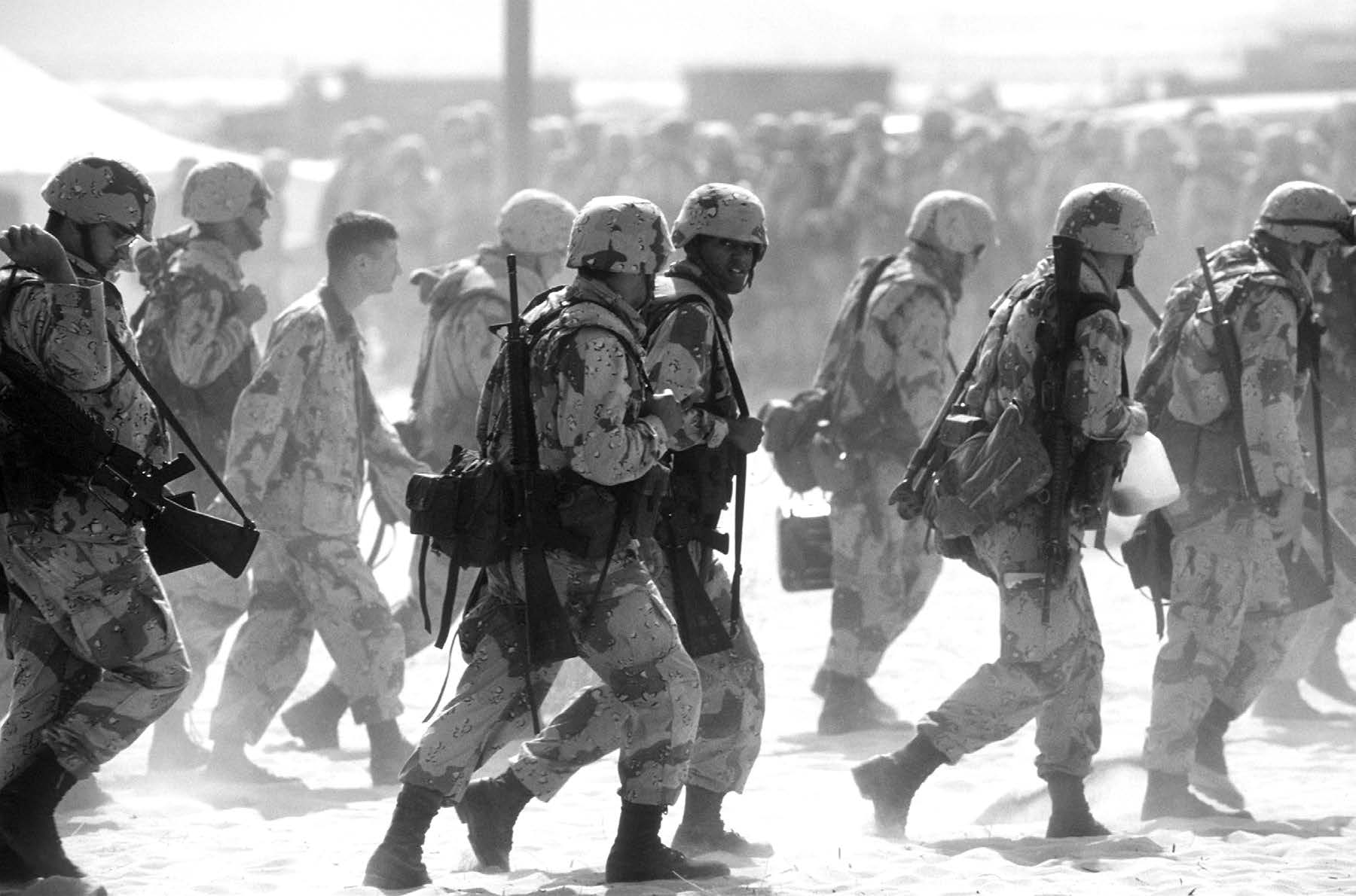 Newly arrived Marines move through an airfield encampment during Operation Desert Shield. Courtesy of DoD.