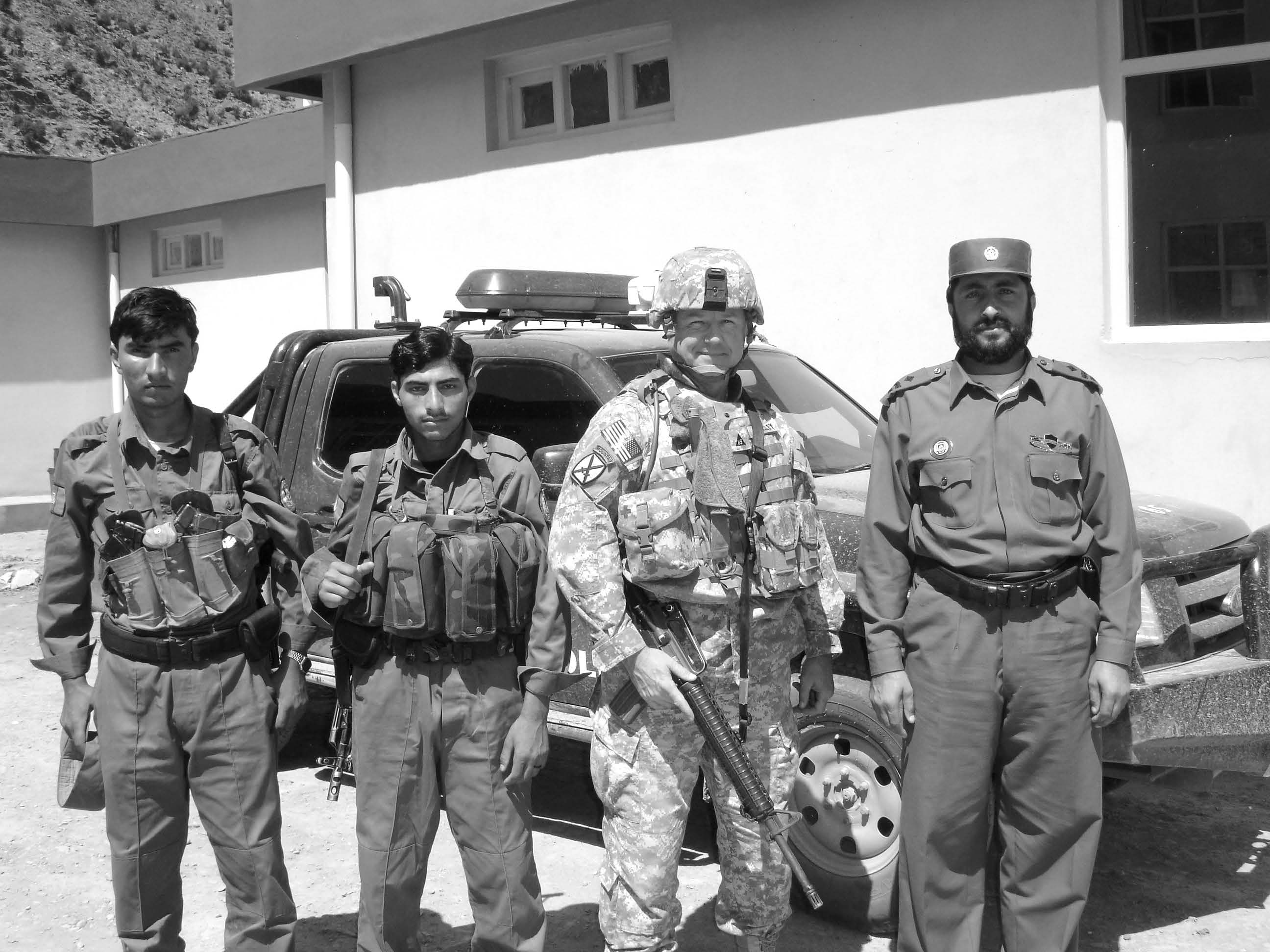 Michael Beesley (second from right) is shown with three Afghan soldiers. Courtesy of Michael Beesley.