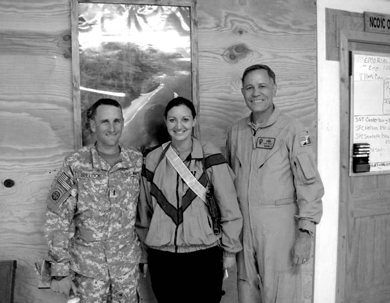 Donald and Lilia Bullock share a moment with Church district president Gene Wikle (right) in Afghanistan. Courtesy of Eugene J. Wikle.