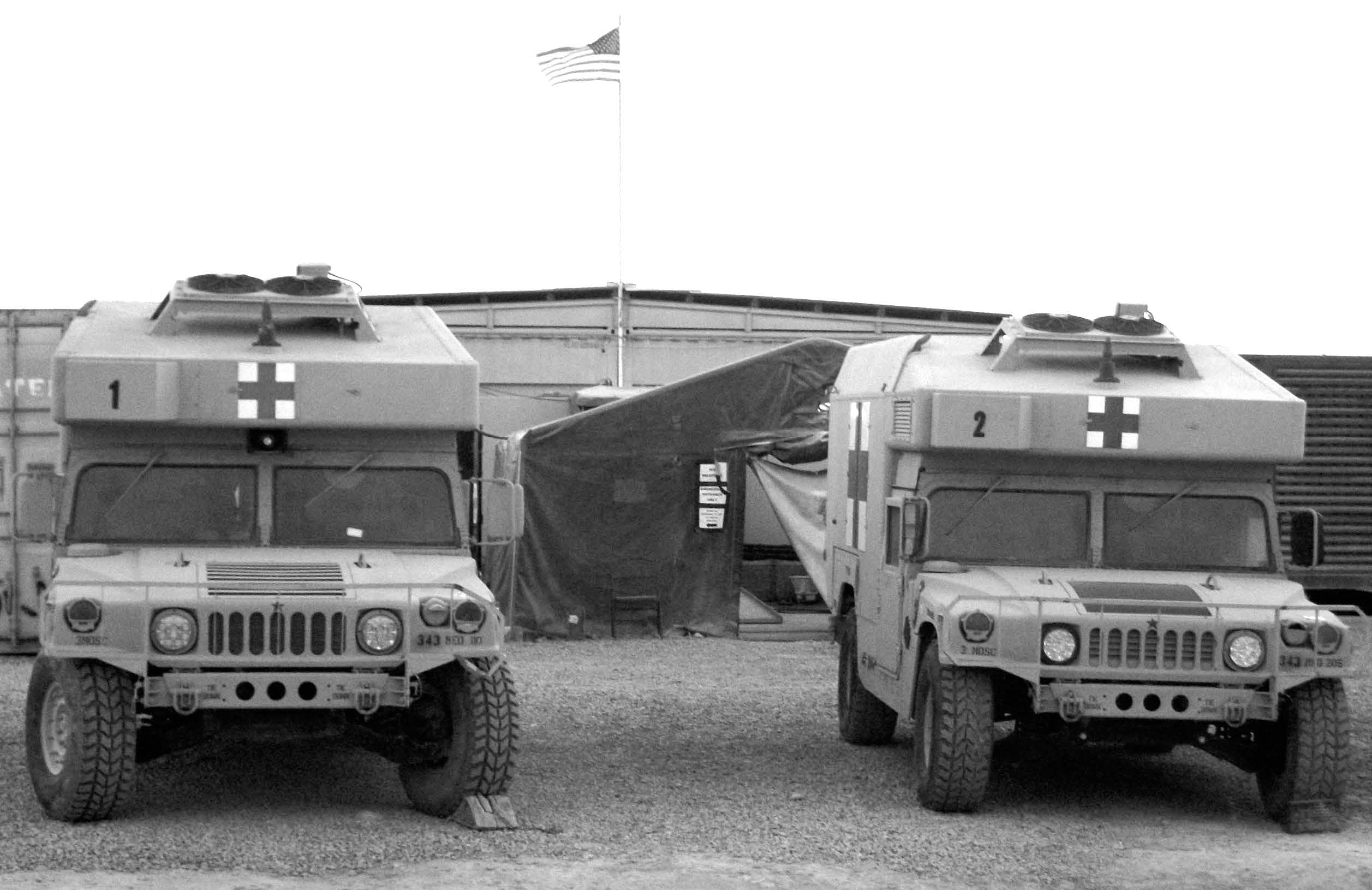 Two Humvees, modified to serve as ambulances, are pictured in front of U.S. Medical Role 2E Hospital at Camp Holland, Tarin Kowt, Afghanistan. Courtesy of Brady Cox.