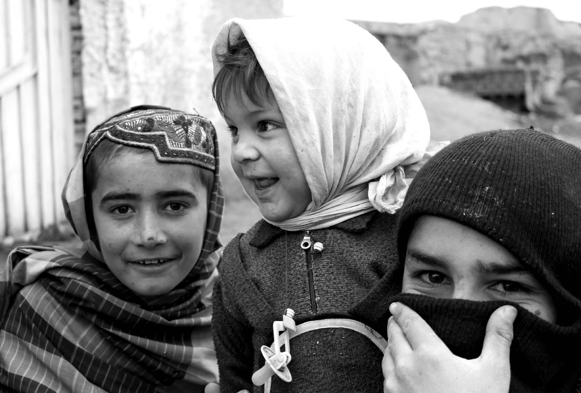 Afghan children greet American soldiers visiting their village. Courtesy of J. Joseph DuWors.