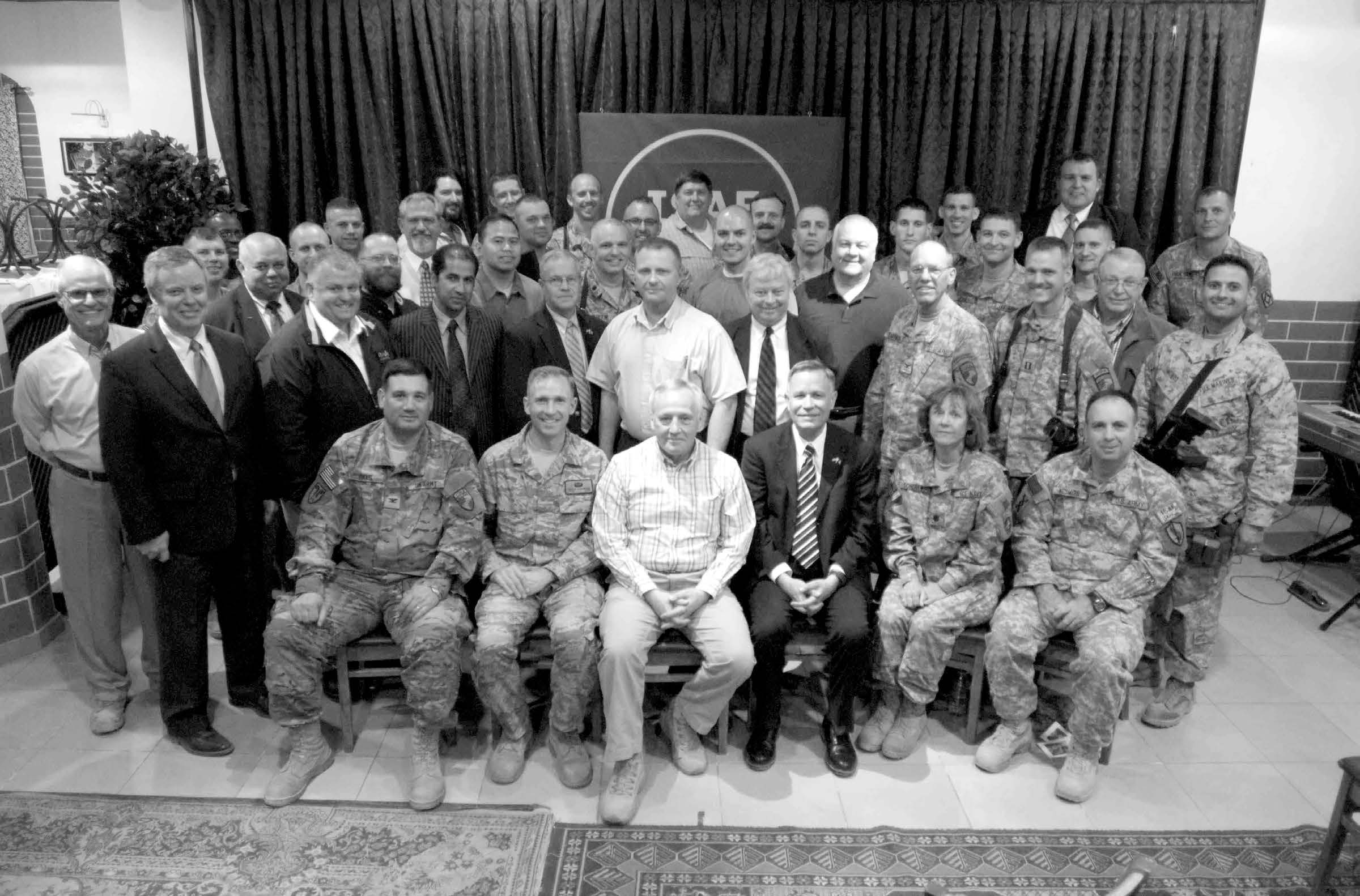 Fifty-eight members of the Church from the Kabul Branch and four nearby service member groups—along with invited guests including the Headquarters, International Security Assistance Force chaplain—attended a meeting to hear Elder Bruce A. Carlson (seated, third from left) speak. Courtesy of Eugene J. Wikle.