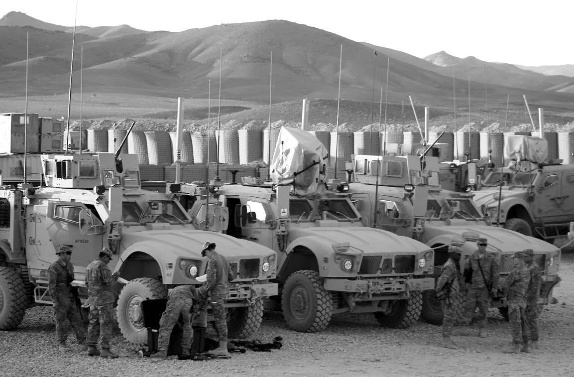 Soldiers check their vehicles prior to leaving their base. Courtesy of J. Joseph DuWors.