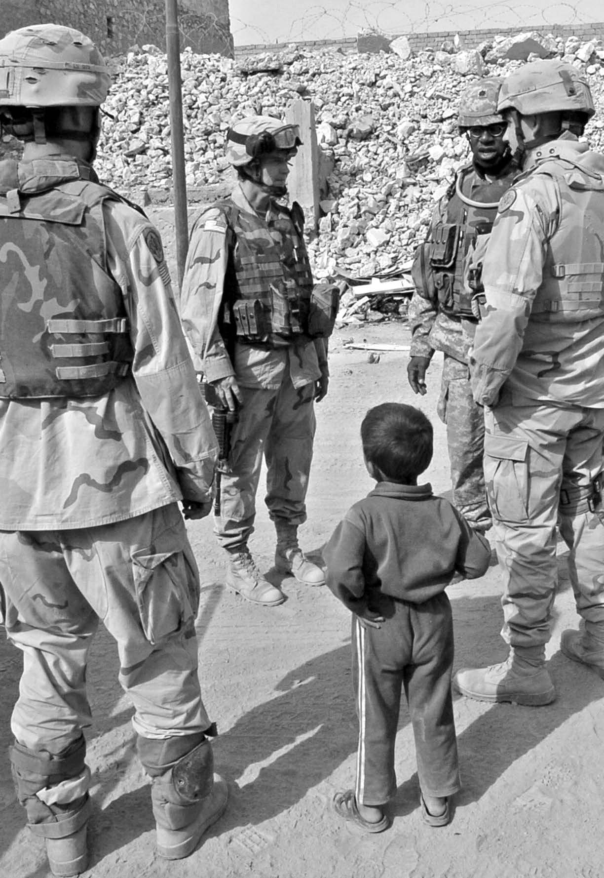 A local Iraqi boy observes U.S. Army soldiers in downtown Tall Afar, Iraq, on October 11, 2005. Courtesy of DoD.