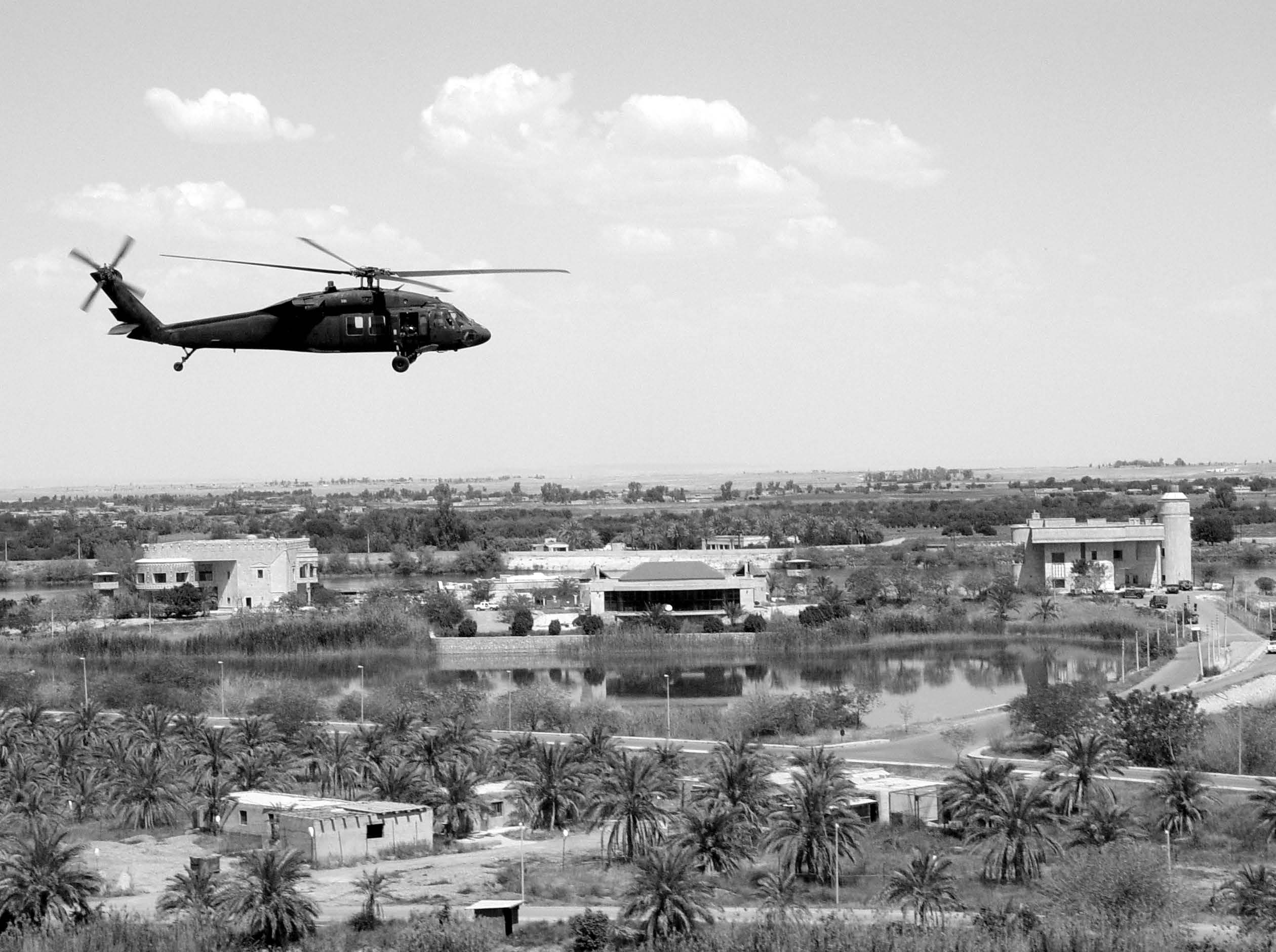 A Blackhawk helicopter from the 106th Aviation Regiment, Illinois Army National Guard flies past one of Saddam Hussein’s former palaces in Tikrit, Iraq. Courtesy of DoD.