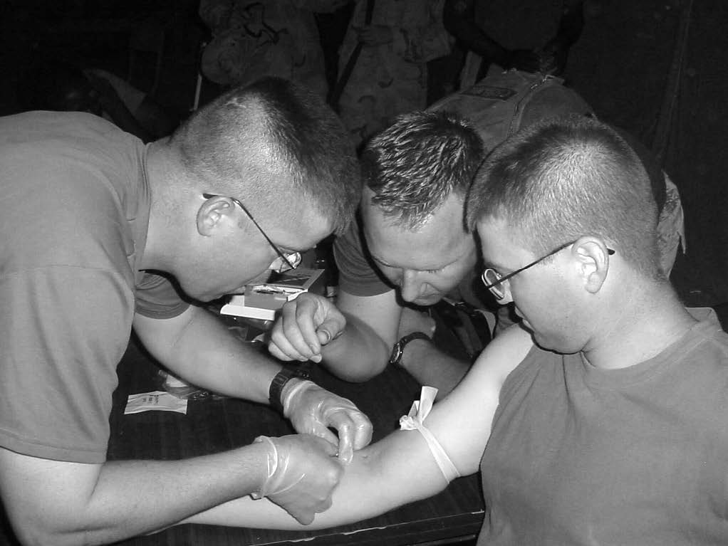 Chaplain Christopher Degn serving in a medical assistance role. Courtesy of Christopher Degn.