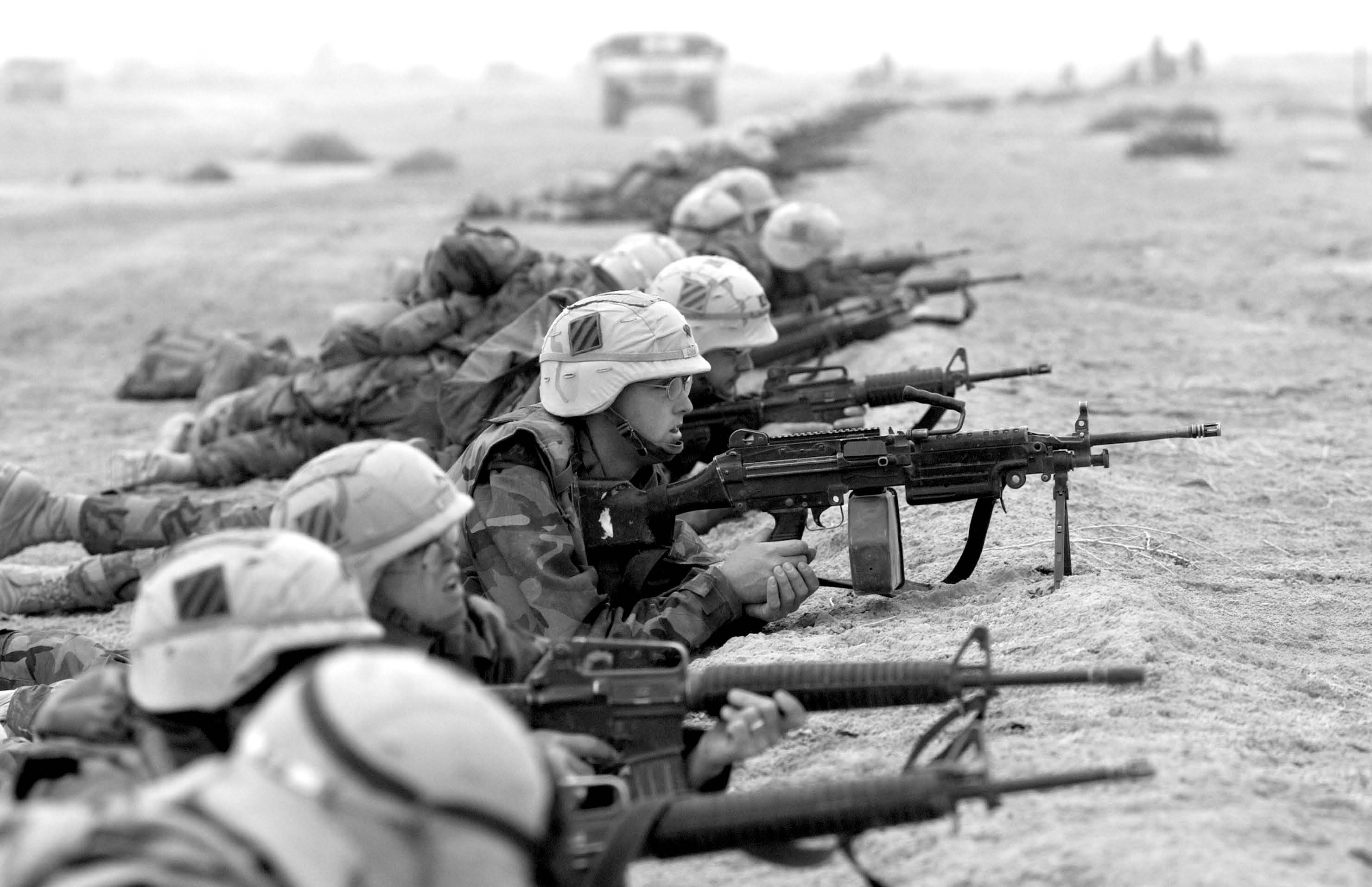 Soldiers from the 3rd Infantry Division in firing positions during an enemy approach on their position in southern Iraq on March 24, 2003. Courtesy of DoD.