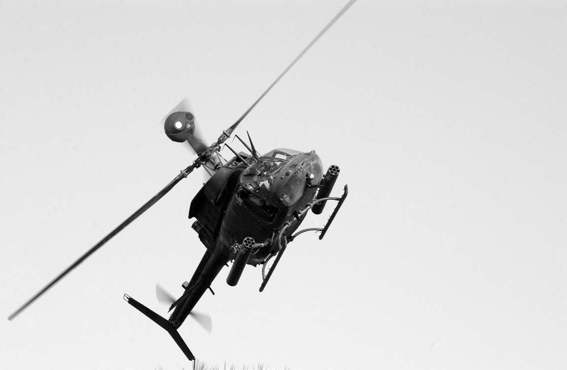 A U.S. Army Kiowa helicopter provides aerial support during a joint U.S. and Iraqi National Guard weapons cache sweep of the Tigris River area in the Al Rashid District of Baghdad on July 15, 2004. Courtesy of DoD.