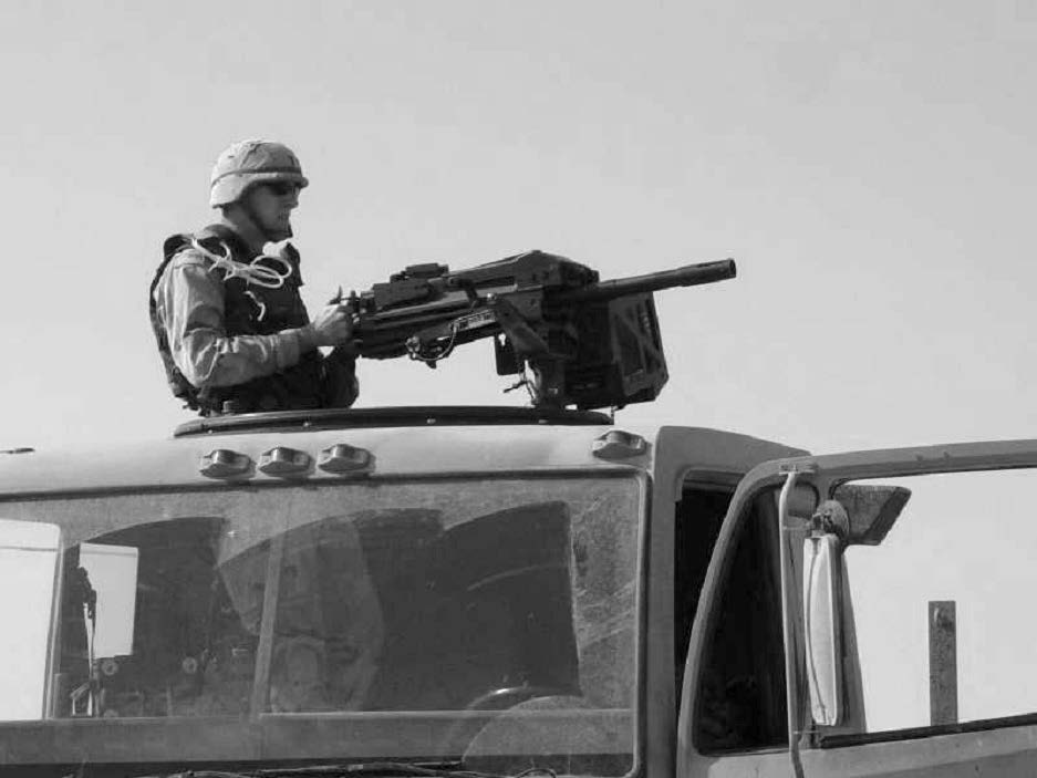 A soldier is shown in a protective overwatch position during a combat logistics patrol to an outlying forward operating base. Courtesy of Steve Gundry.