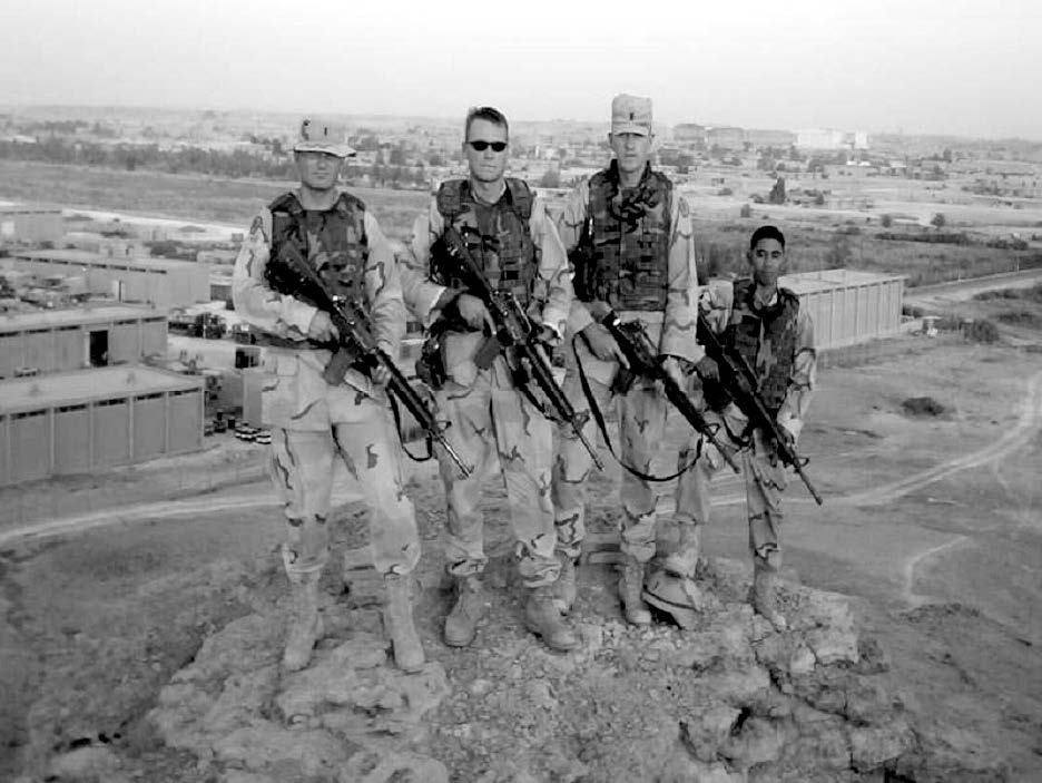 Support squadron lieutenants shown on a cliff overlooking Al Asad Air Base only days after a ground assault captured the air base from the Iraqi air force. Courtesy of Steve Gundry.