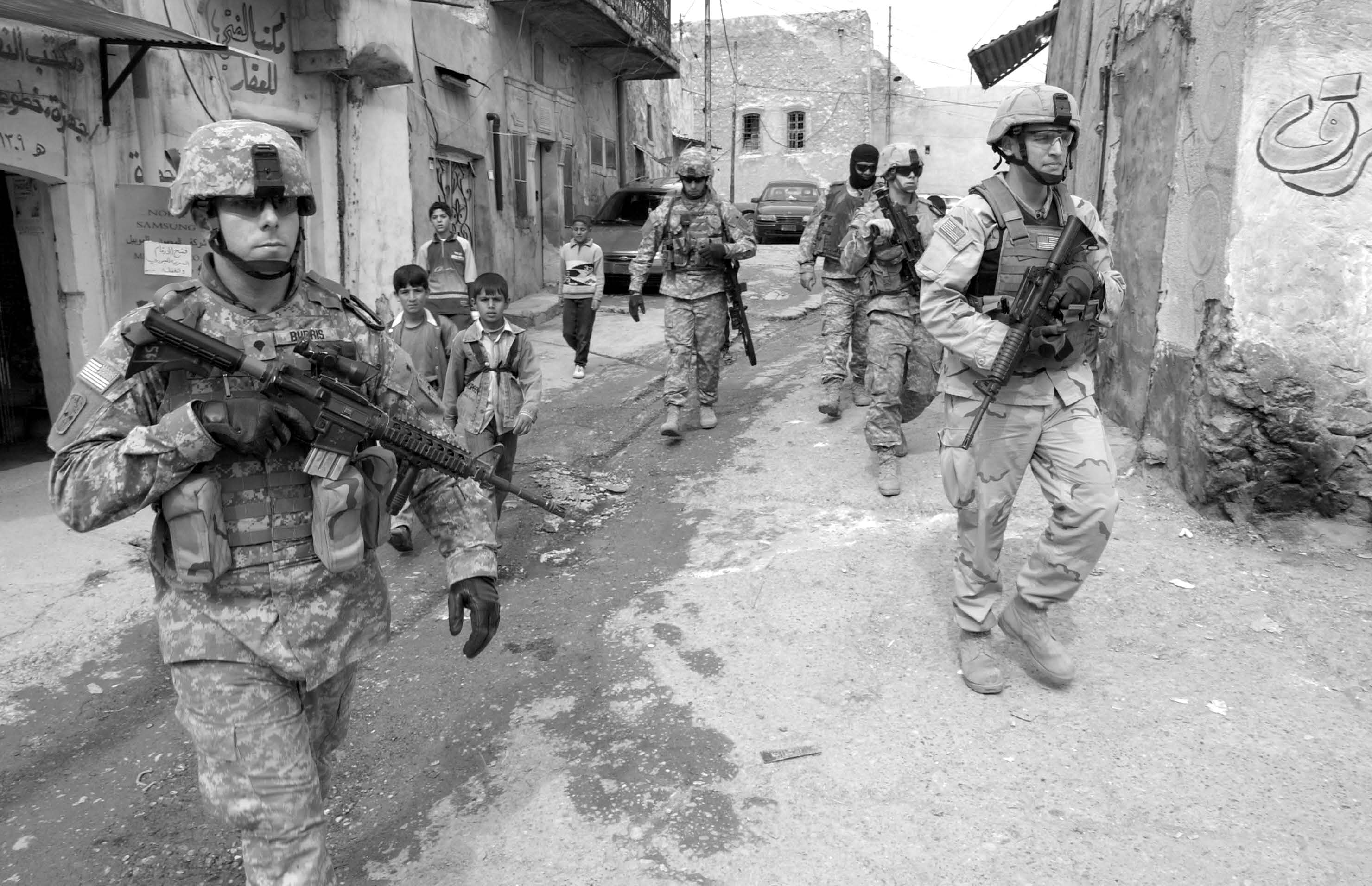Soldiers from the U.S. Army’s 172nd Stryker Brigade Combat Team patrol the streets of Tall Kayf, Iraq, on March 1, 2006. Courtesy of DoD.