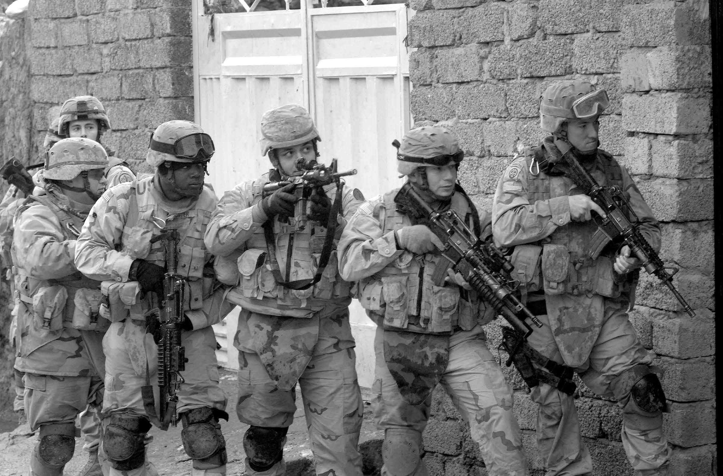 Soldiers from the U.S. Army’s 3rd Armored Cavalry Regiment prepare to enter a building during a combat patrol in Tall Afar, Iraq, on February 7, 2006. Courtesy of DoD.