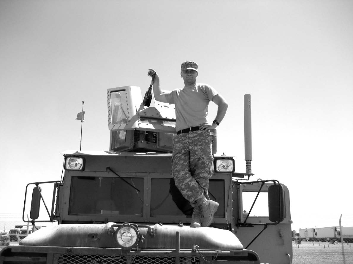 Specialist Bernt Jenkins, standing on his guntruck at FOB Q-West, is waiting for a mission to begin in August 2007. Courtesy of Bernt Jenkins.