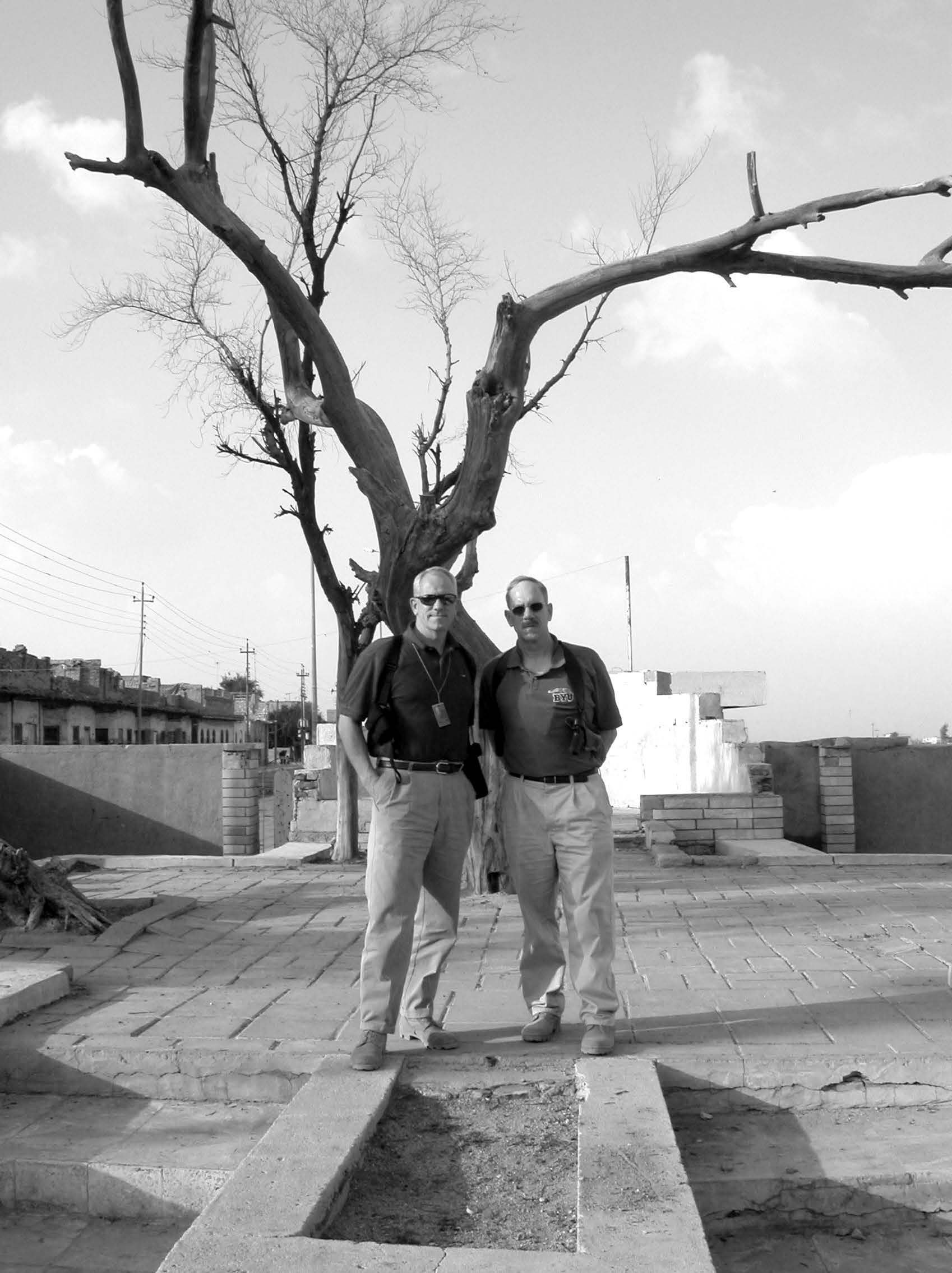 Lieutenant Colonel Kevin R. Riedler (right) and Colonel Jim Slavin are pictured standing in front of the “Adam Tree” near where the Tigress and Euphrates Rivers meet—a site traditionally accepted by some people as the location of the Garden of Eden. Courtesy of Kevin R. Riedler.