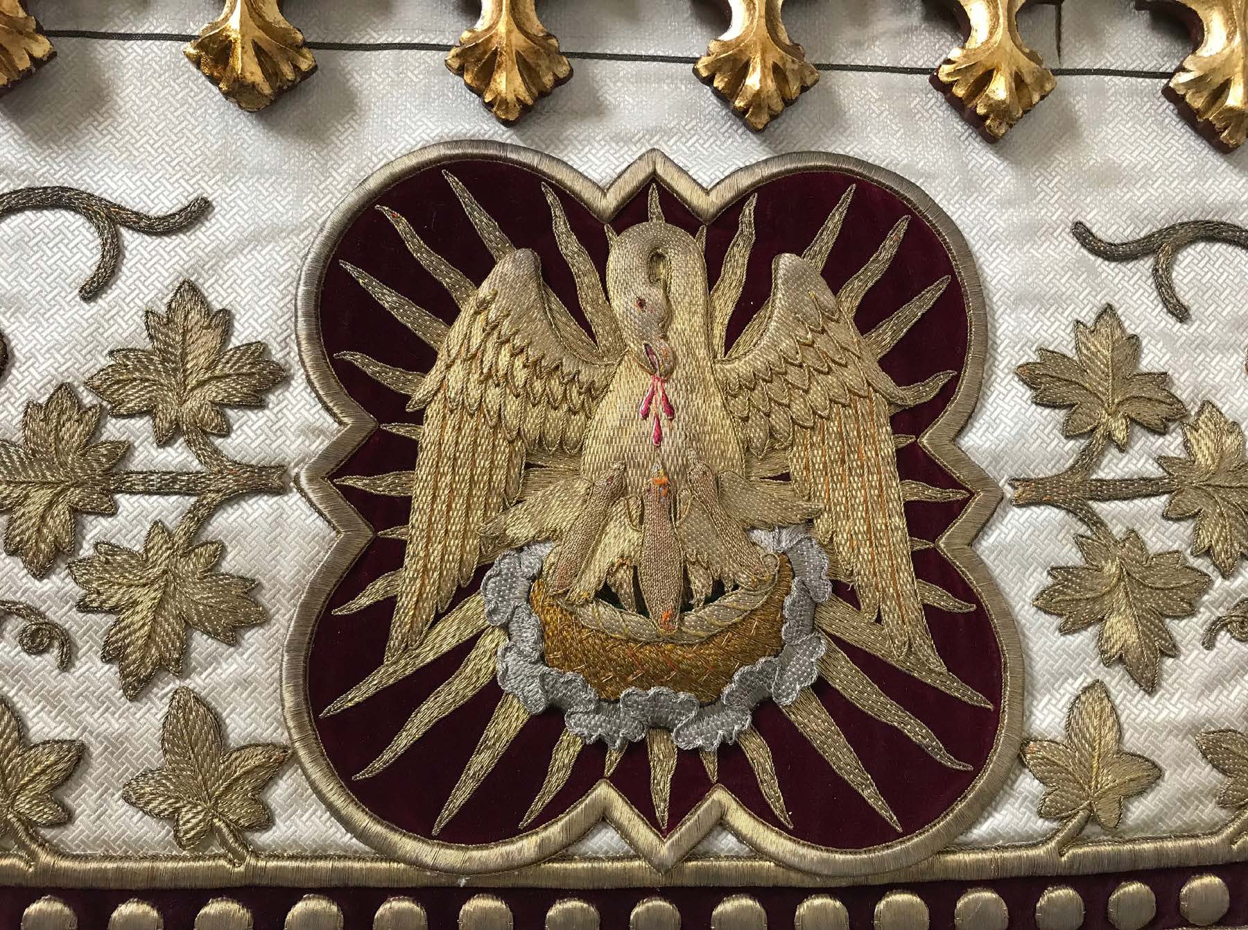 The legend tells how the pelican brought its young back to life by striking its own breast with its beak. Sint-Niklaaskerk, embroidery on processional canopy. Veurne, Belgium.