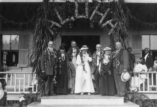 President Joseph F. Smith and his party in front of the Laie Social Hall during their 1915 visit. From left to right: President Smith and his wife Julina, Elder Reed Smoot and his wife Alpha, Bishop Charles Nibley and his wife Rebecca, and Samuel E. Woolley. During this visit the prophet noted positive changes in the spiritual and financial well-being of the Church and improved conditions in Hawaiʻi in general. Courtesy of Church History Library
