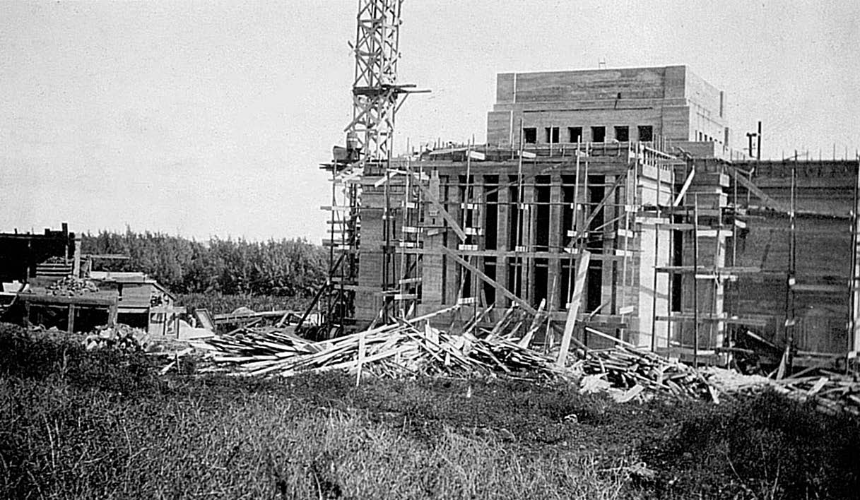 West side view of the temple under construction, with rock-crushing equipment at left.
