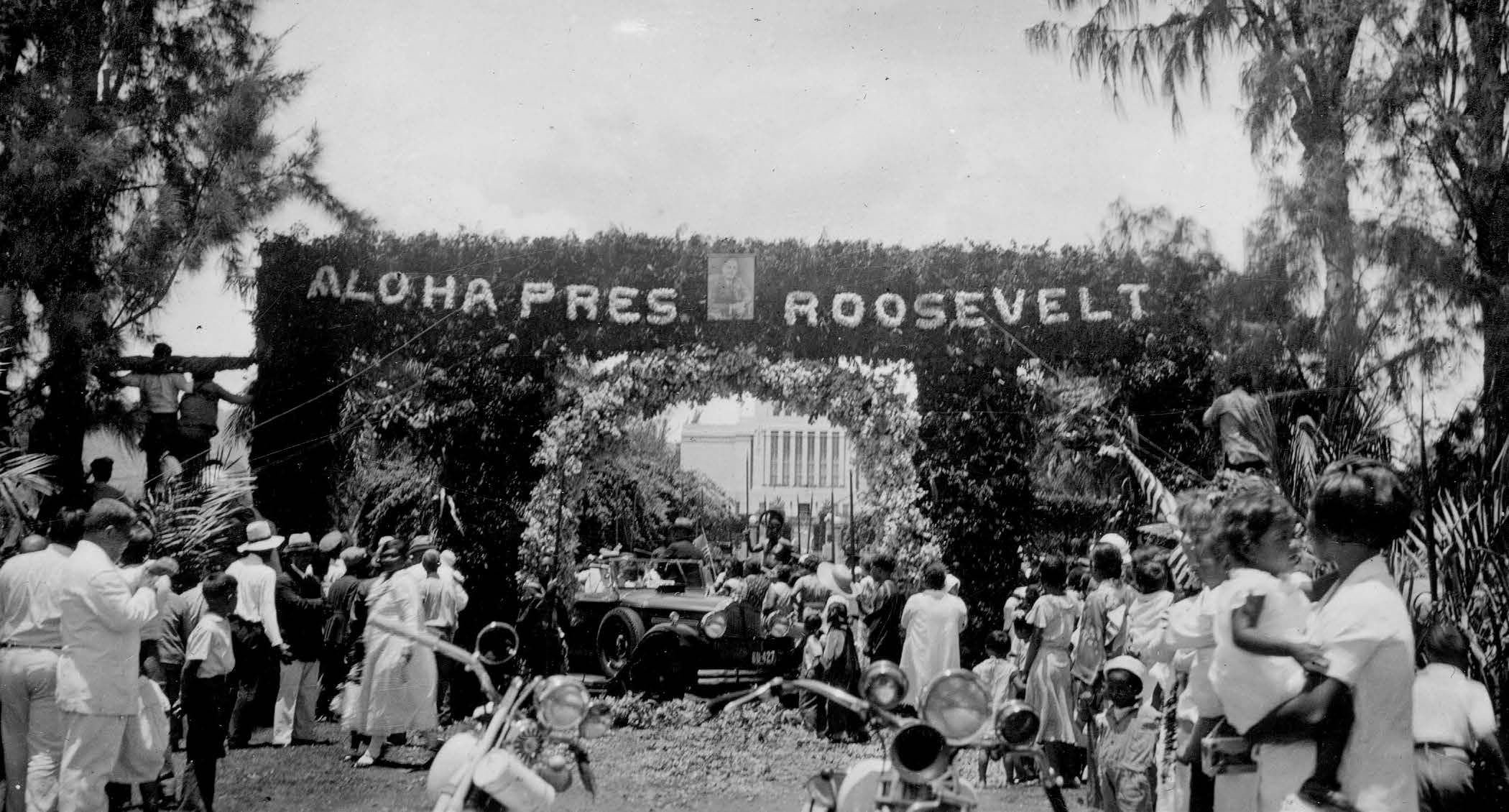 In 1934 the Lāʻie community received President Franklin D. Roosevelt in front of the temple during his tour of Hawaiʻi. President Roosevelt is in the car beneath the archway with the temple in the background. Courtesy of BYU–Hawaii Archives.