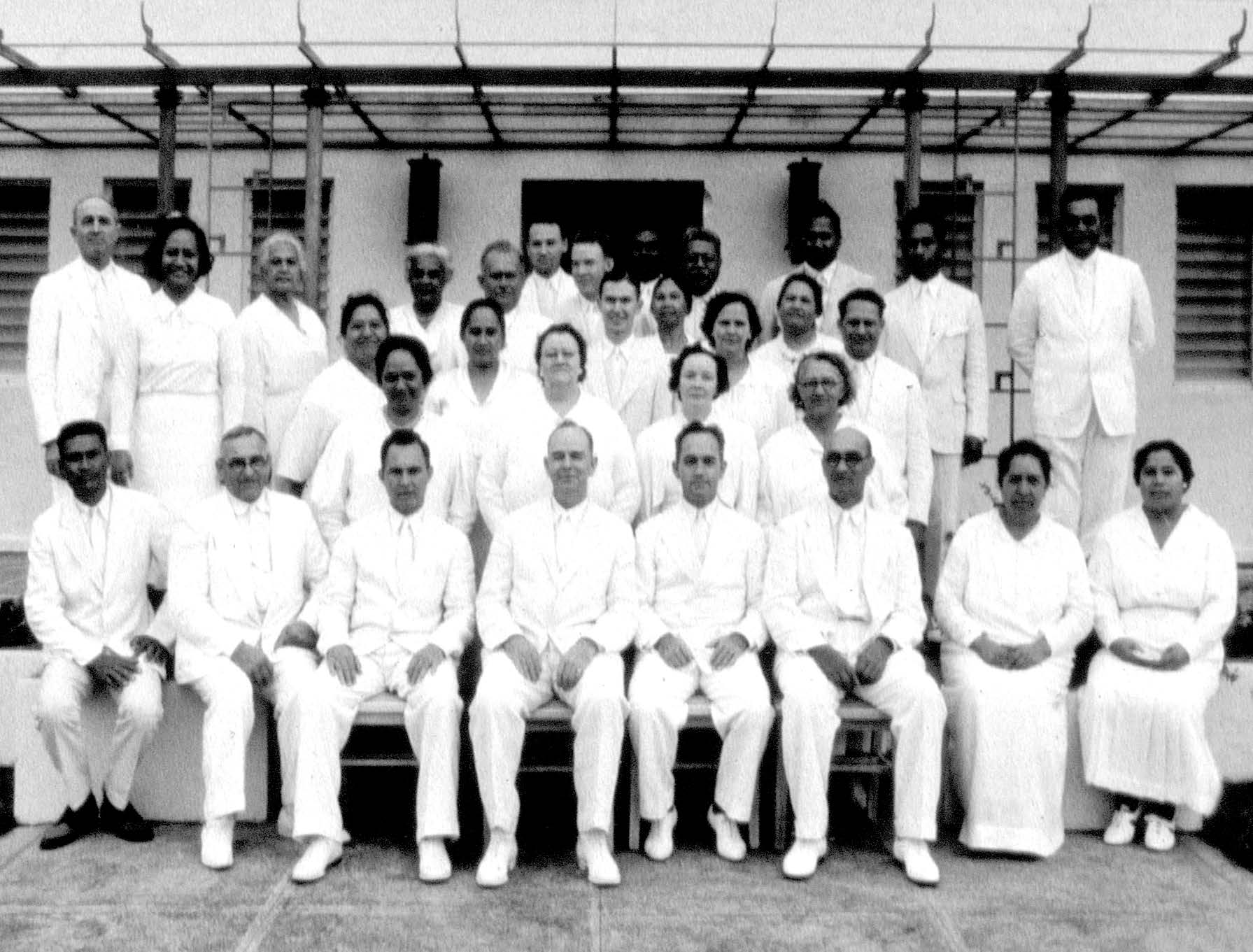 Temple workers, circa 1938–41. Temple president Castle Murphy (seated fourth from left) and his wife Verna (directly behind him) took pride in training members of varied nationalities to perform the parts, ceremonies, and ordinances of the temple, noting that at times “companies were served by natives alone.” Courtesy of BYU–Hawaii Archives.