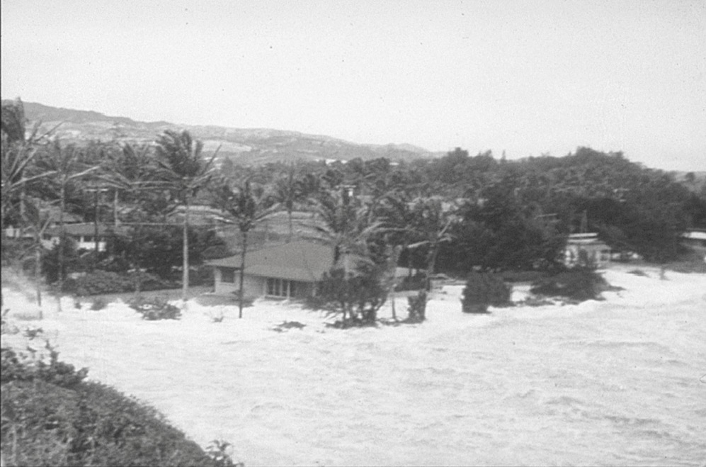 A deadly tsunami had struck Hawaiʻi in 1946. When a warning siren sounded a decade later on Saturday, 9 March 1957, those in the temple prayed for protection. No lives were lost. Photo of the wave surging over the beach directly east of the temple courtesy of BYU–Hawaii Archives.