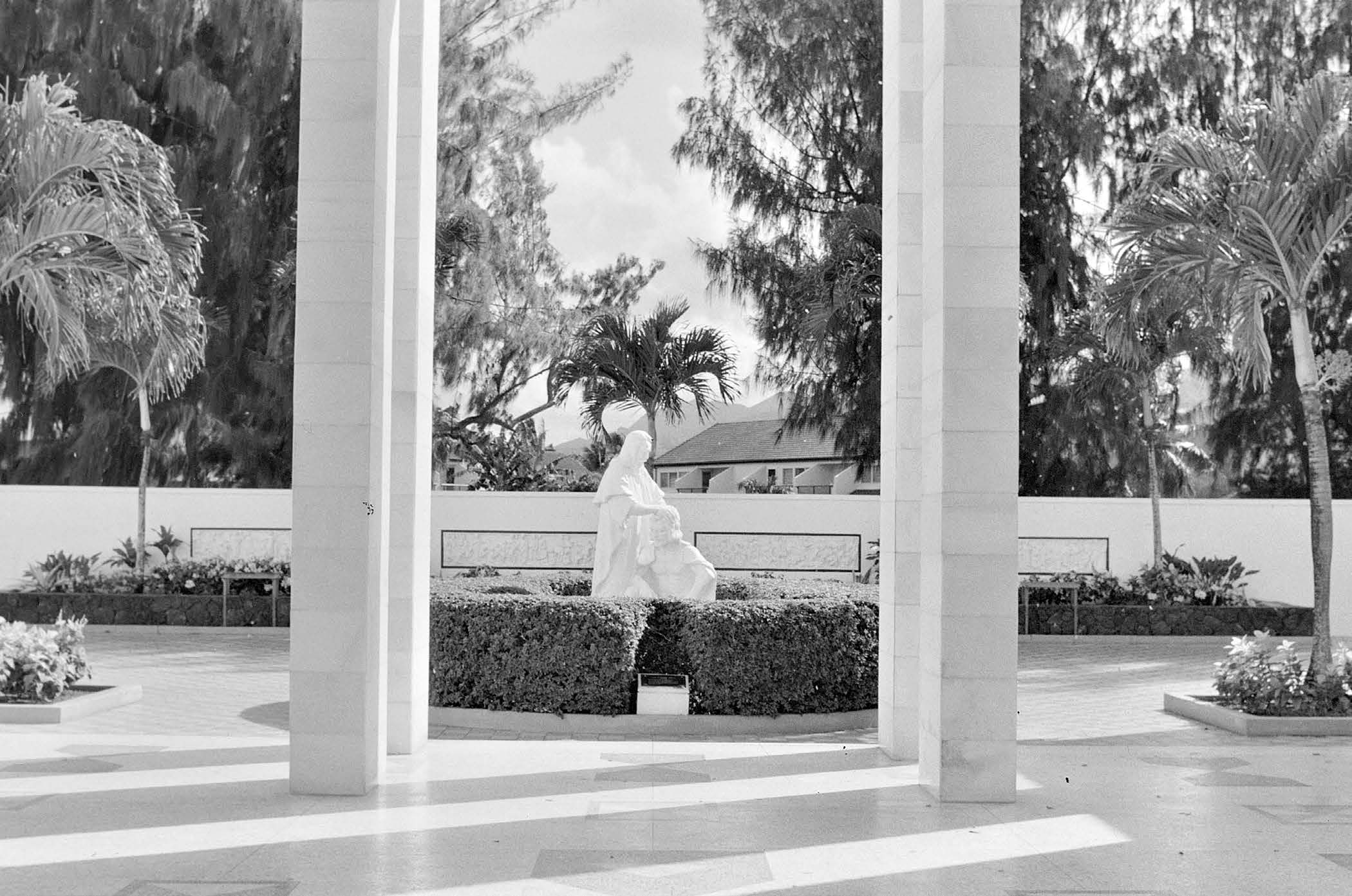 Among several improvements made to the temple grounds in 1988, the sculpture Lehi Blessing Joseph and replicas of the four friezes were added to the courtyard opposite the main visitors’ center. Courtesy of BYU–Hawaii Archives.