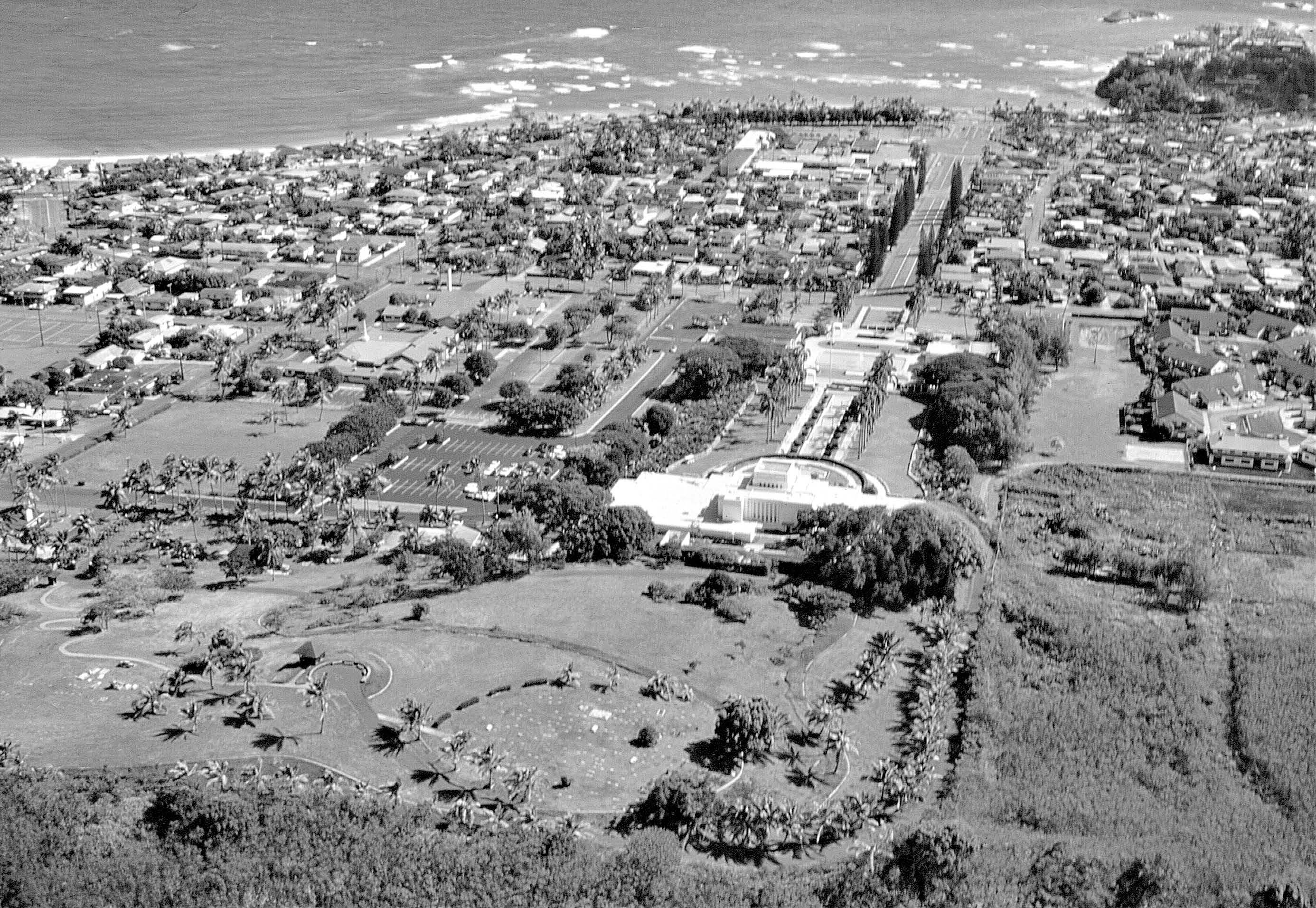 Extending back and to the north of the temple, the park area and Laie Pioneer Memorial Cemetery have greatly added to the use, beauty, and peace of the temple grounds. Courtesy of BYU–Hawaii Archives.
