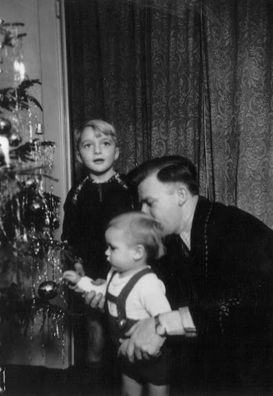 little boy decorating a christmas tree