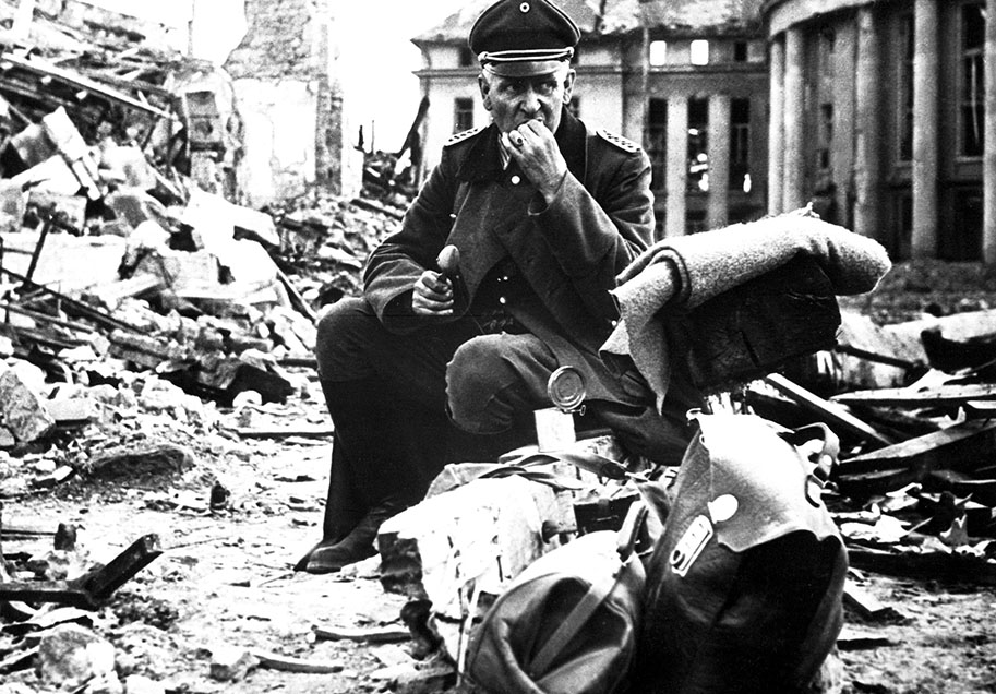 officer sitting on rubble