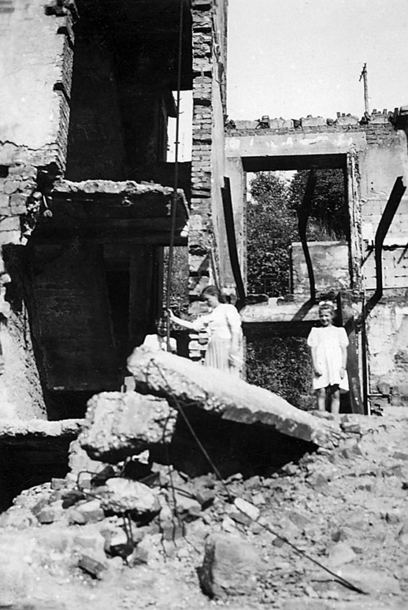 girls playing on ruins of a house