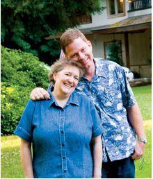 husband and wife standing together outside