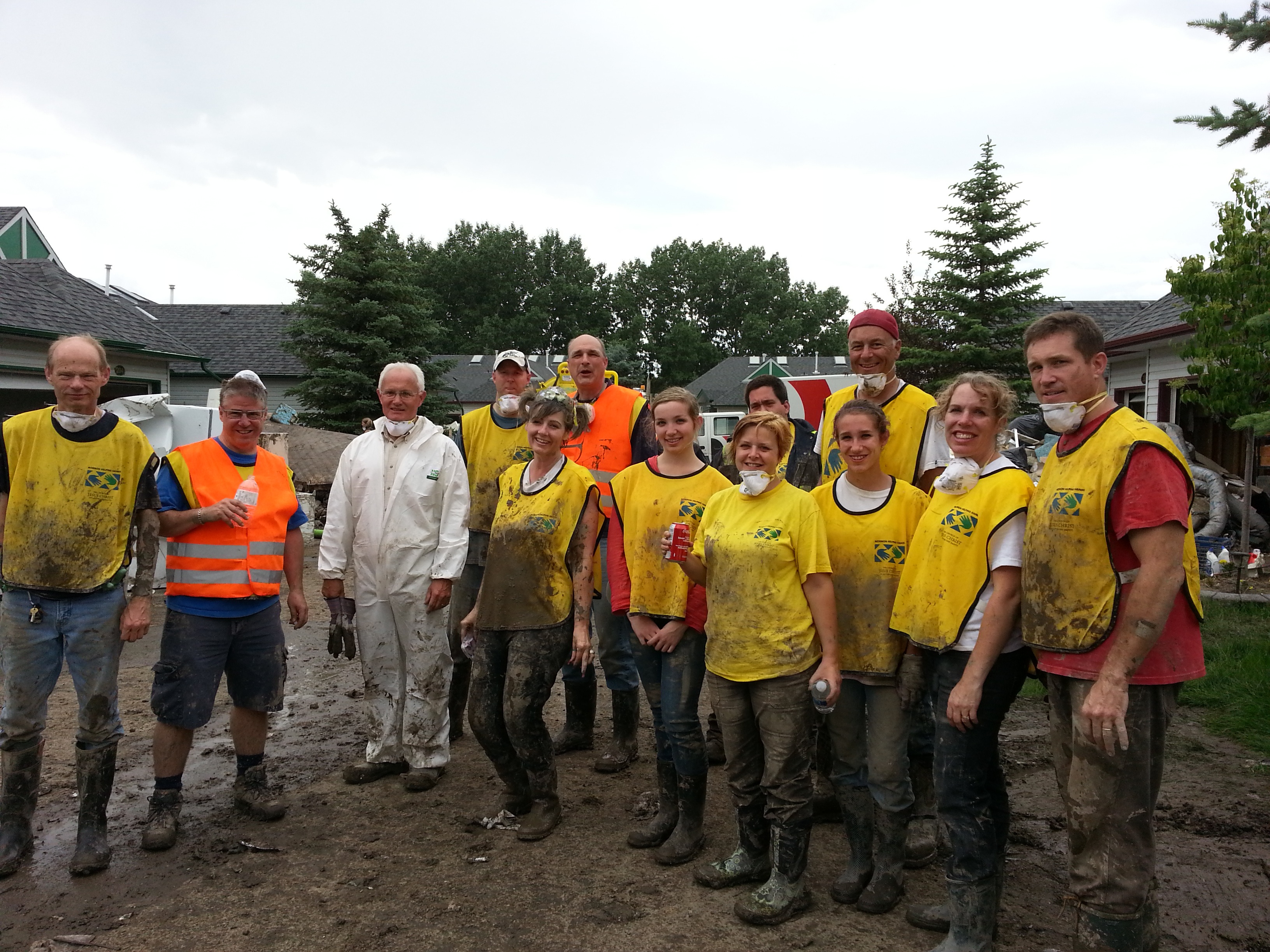 Several men wearing yellow mormon helping hands shirts