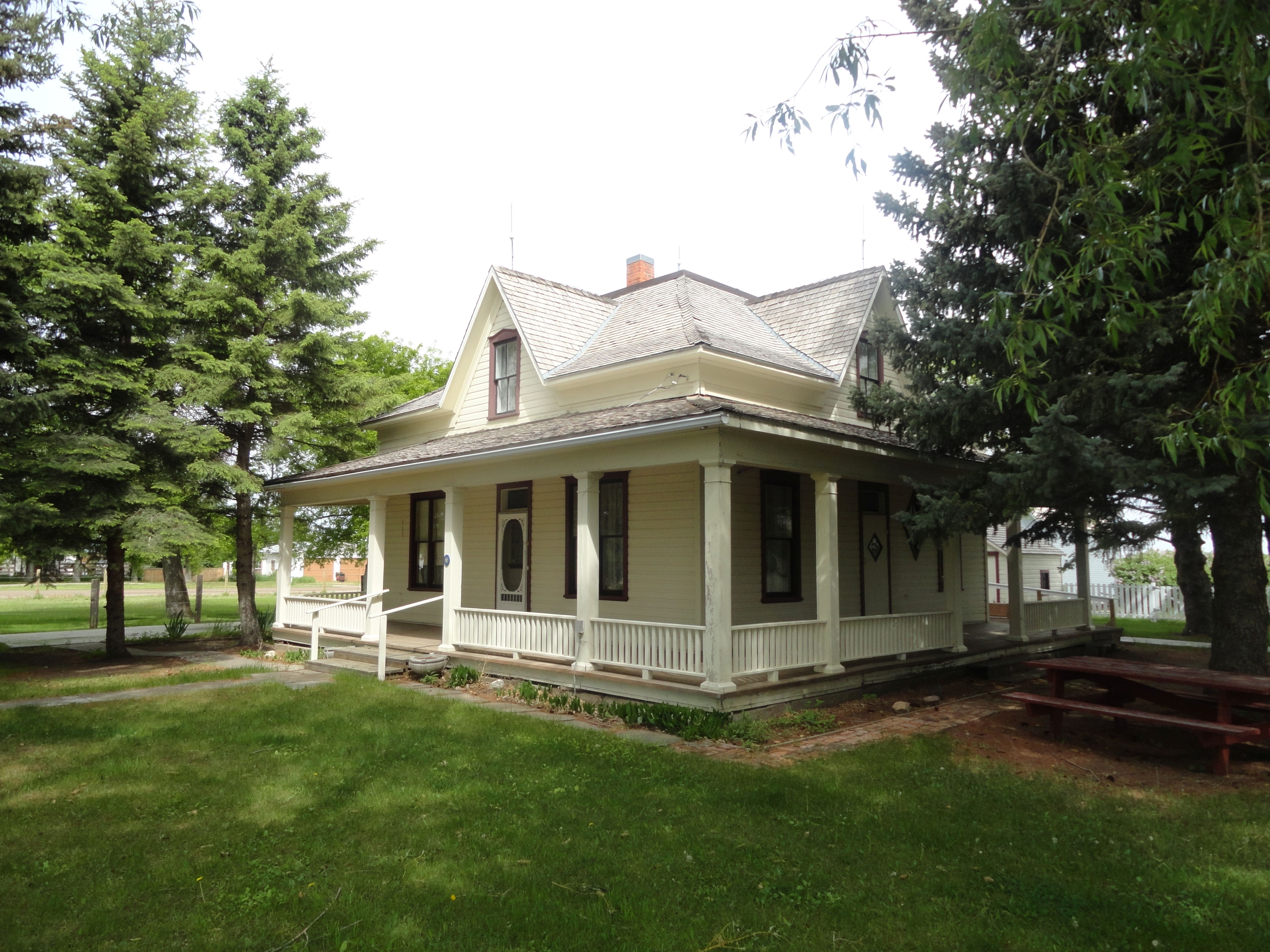 home with a a porch and land