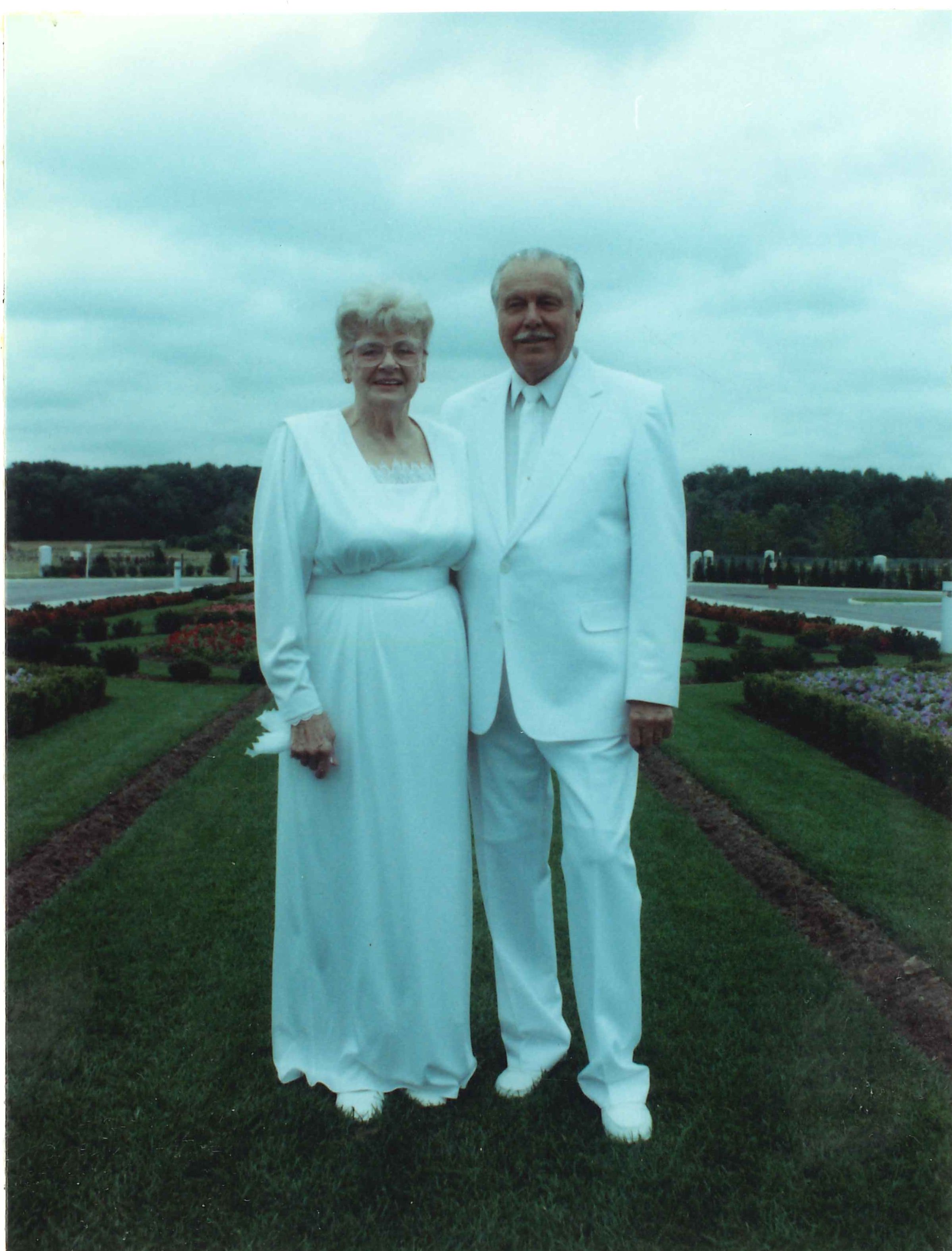A husband and wife dressed in white