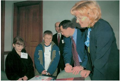 two children with the government officials